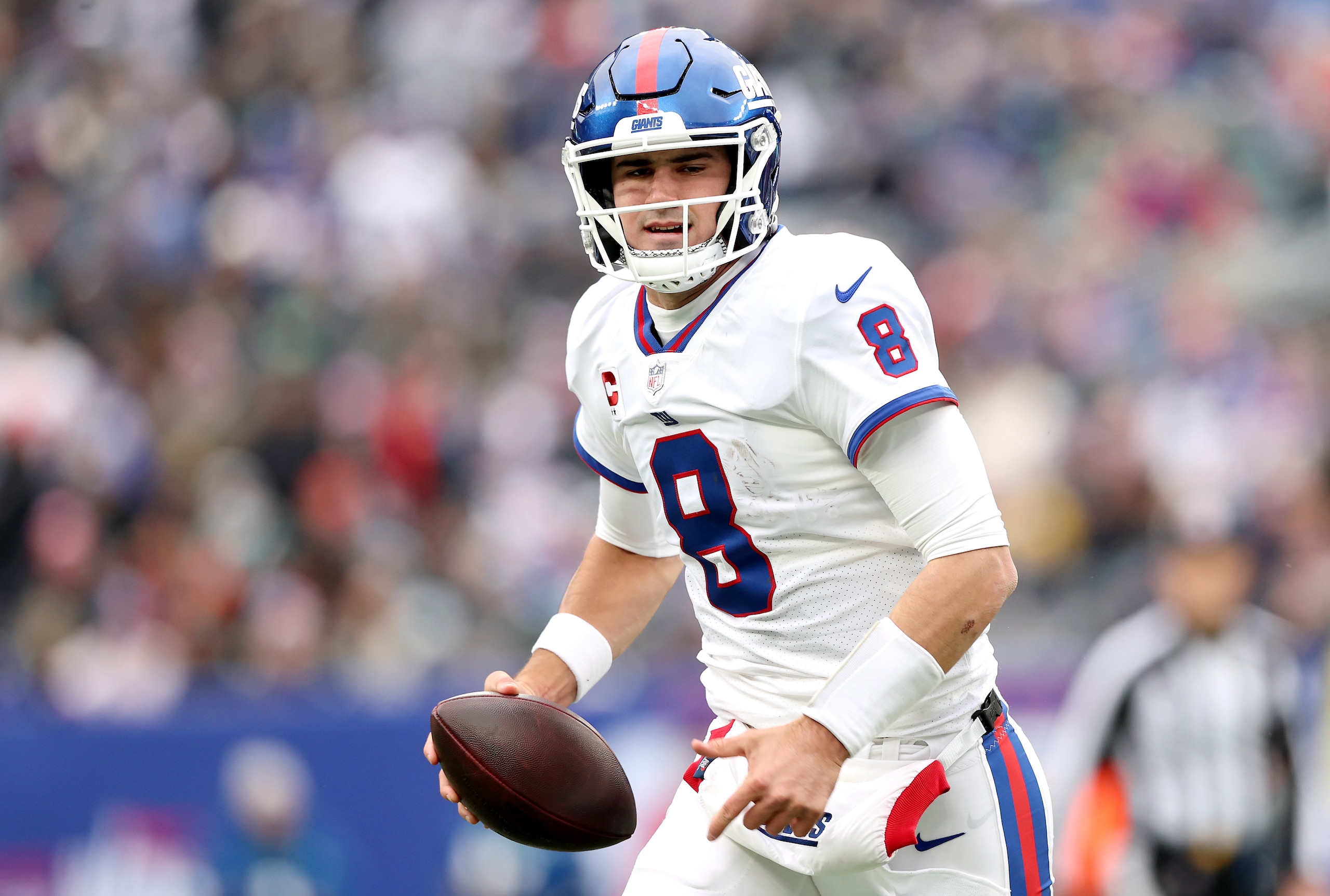 EAST RUTHERFORD, NEW JERSEY - NOVEMBER 28: Daniel Jones #8 of the New York Giants runs with the ball against the Philadelphia Eagles in the first quarter at MetLife Stadium on November 28, 2021 in East Rutherford, New Jersey. (Photo by Elsa/Getty Images)