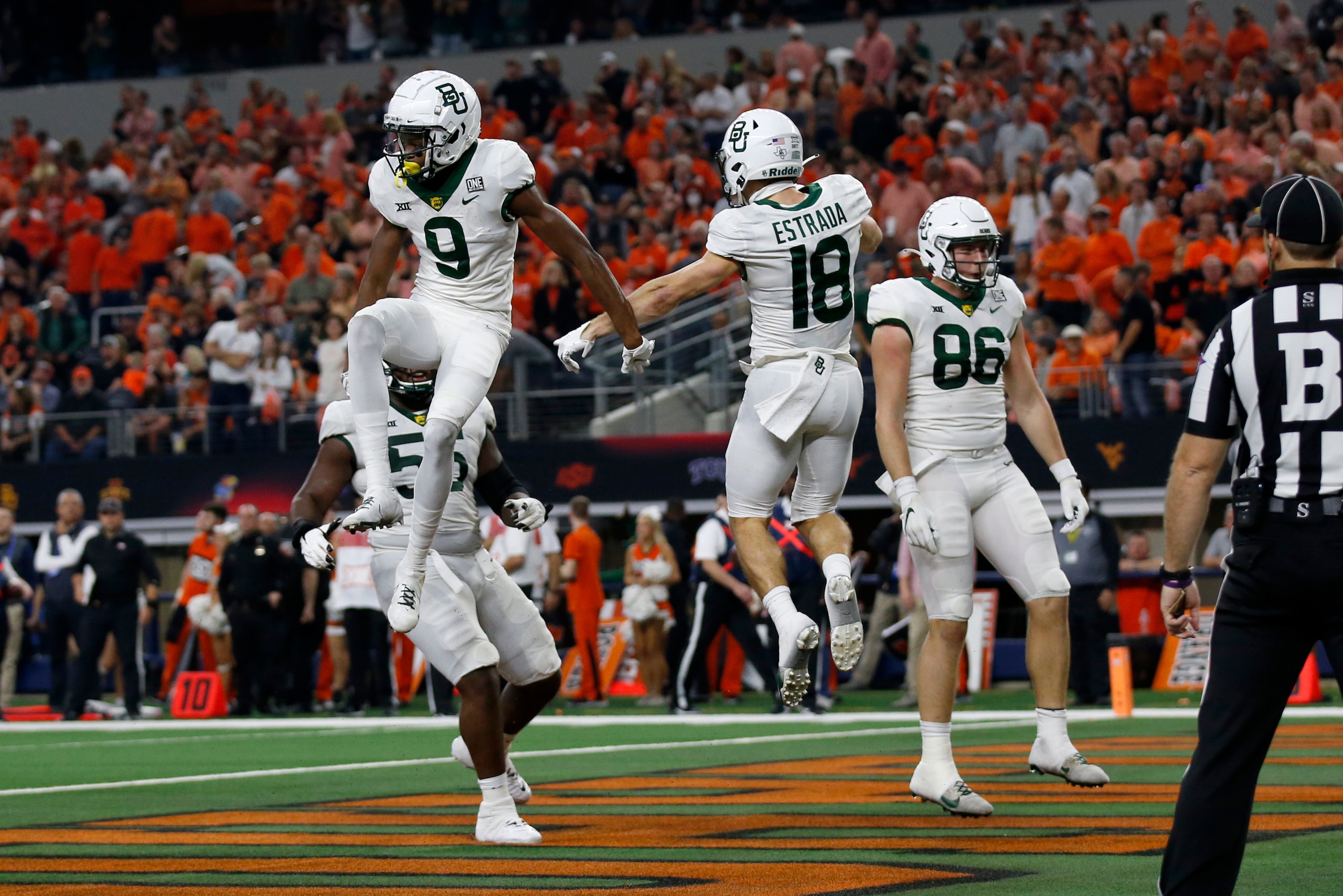 Baylor wide receiver Tyquan Thornton (9) celebrates a touchdown catch with wide receiver Drew Estrada (18) and tight end Ben Sims (86) during the first half of the Big 12 Championship NCAA college football game against Oklahoma State in Arlington, Texas, Saturday, Dec. 4, 2021. (AP Photo/Roger Steinman)