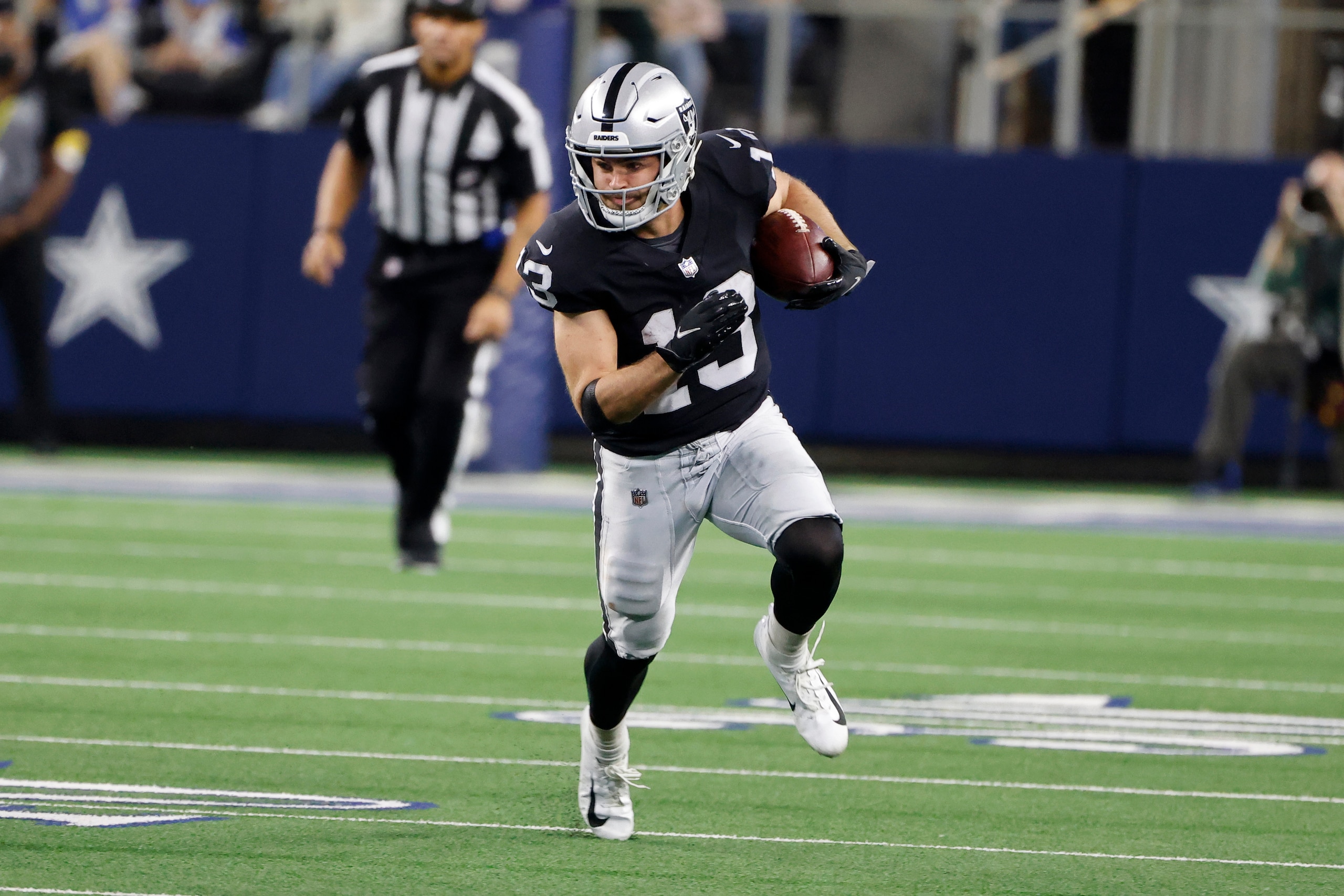 Las Vegas Raiders wide receiver Hunter Renfrow (13) runs after a reception against the Dallas Cowboys during an NFL Football game in Arlington, Texas, Thursday, Nov. 25, 2021. (AP Photo/Michael Ainsworth)