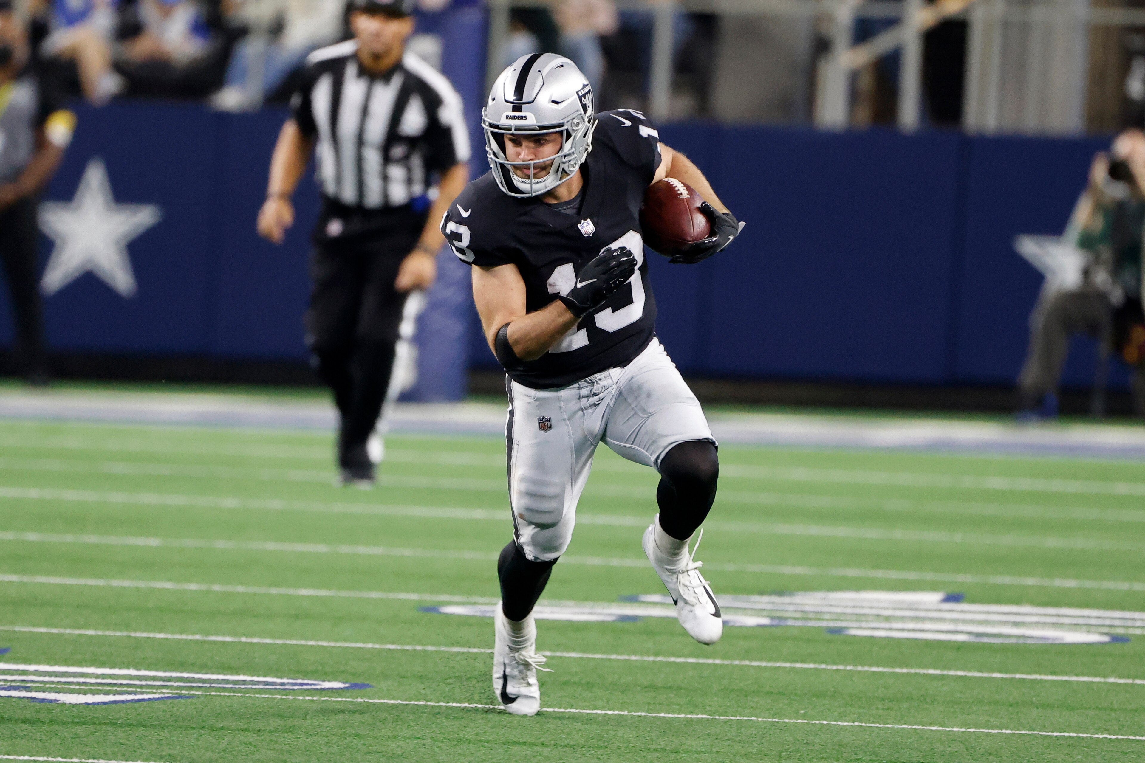 Las Vegas Raiders wide receiver Hunter Renfrow (13) runs after a reception against the Dallas Cowboys during an NFL Football game in Arlington, Texas, Thursday, Nov. 25, 2021. (AP Photo/Michael Ainsworth)