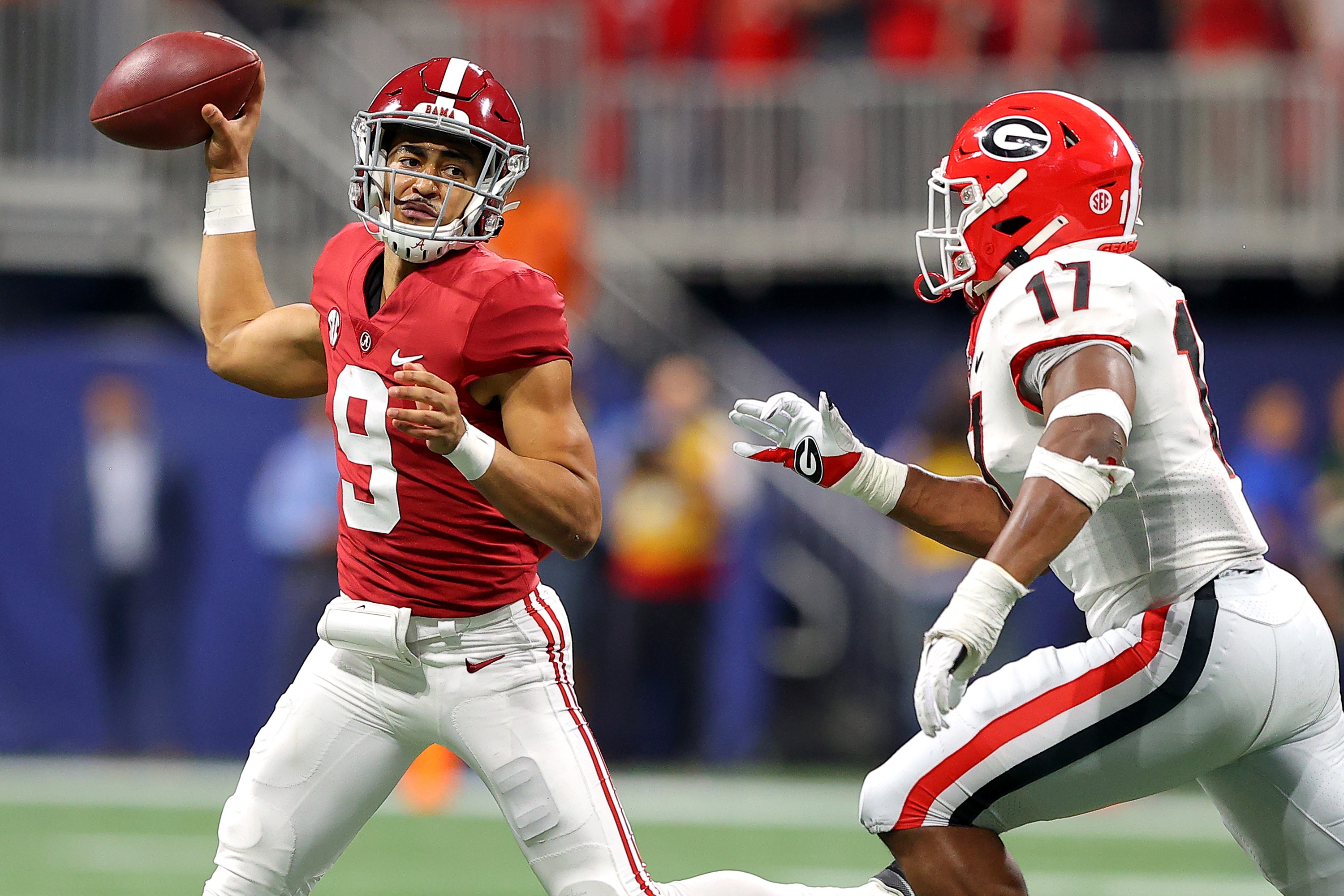 ATLANTA, GEORGIA - DECEMBER 04: Bryce Young #9 of the Alabama Crimson Tide looks to pass as Nakobe Dean #17 of the Georgia Bulldogs defends in the second quarter of the SEC Championship game at Mercedes-Benz Stadium on December 04, 2021 in Atlanta, Georgia. (Photo by Kevin C. Cox/Getty Images)