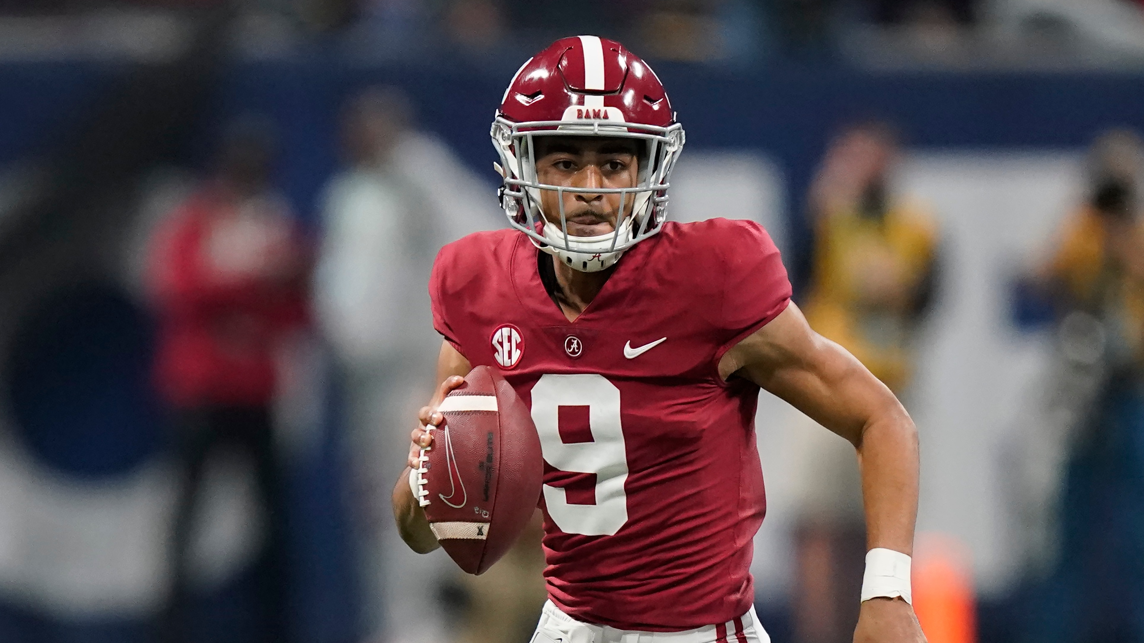 Alabama quarterback Bryce Young (9) runs against Georgia during the first half of the Southeastern Conference championship NCAA college football game, Saturday, Dec. 4, 2021, in Atlanta. (AP Photo/Brynn Anderson)