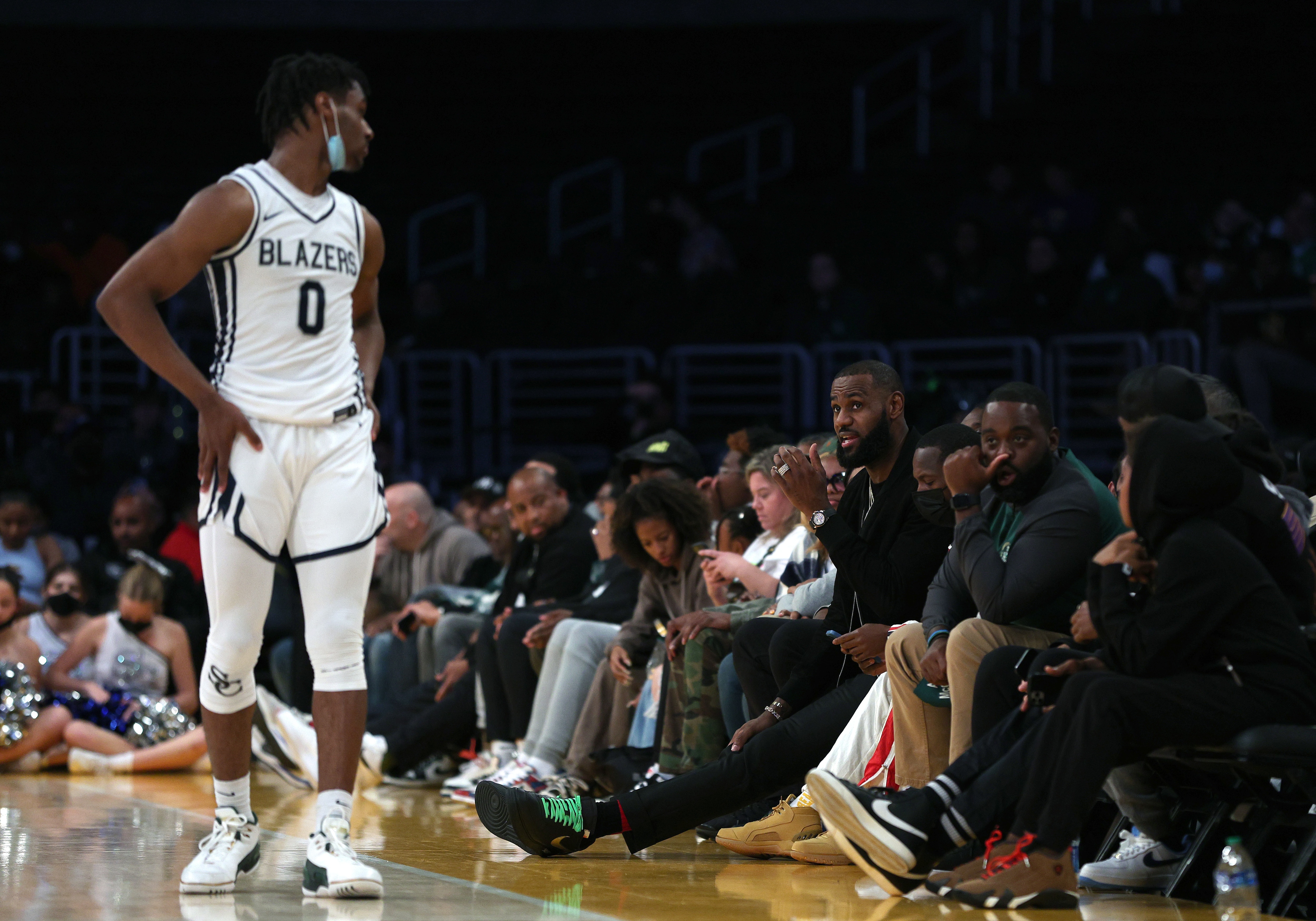LOS ANGELES, CALIFORNIA - DECEMBER 04: LeBron James #6 of the Los Angeles Lakers speaks to his son Bronny James #0 of Sierra Canyon during the game against St. Vincent - St. Mary during The Chosen-1's Invitational at Staples Center on December 04, 2021 in Los Angeles, California. (Photo by Harry How/Getty Images)