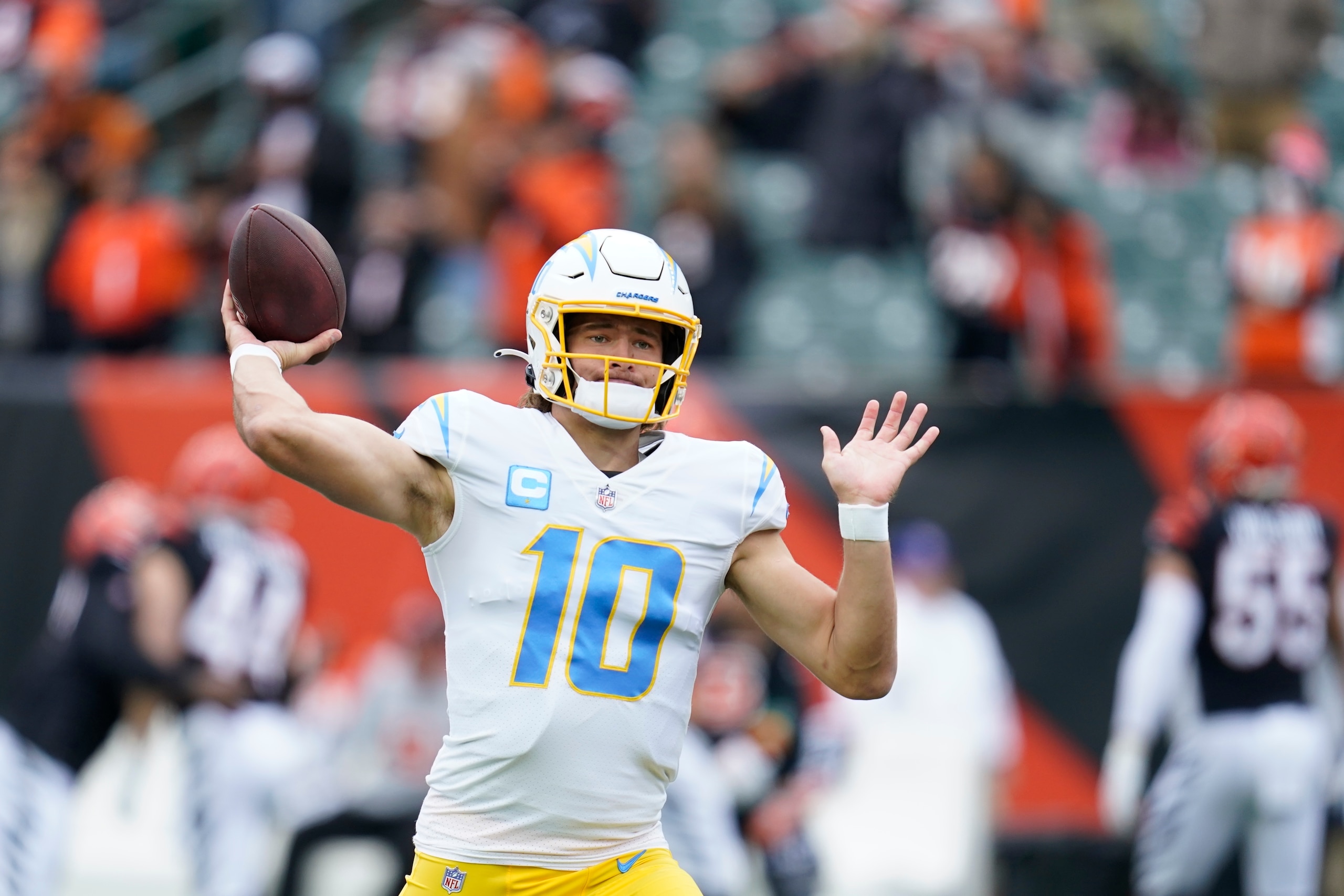Los Angeles Chargers quarterback Justin Herbert throws before an NFL football game between the Cincinnati Bengals and the Los Angeles Chargers, Sunday, Dec. 5, 2021, in Cincinnati. (AP Photo/Michael Conroy)