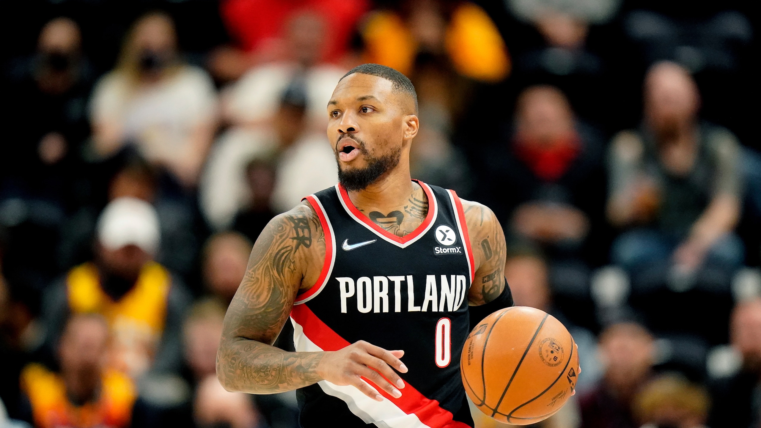 Portland Trail Blazers guard Damian Lillard (0) brings the ball up court in the first half during an NBA basketball game against the Utah Jazz Monday, Nov. 29, 2021, in Salt Lake City. (AP Photo/Rick Bowmer)