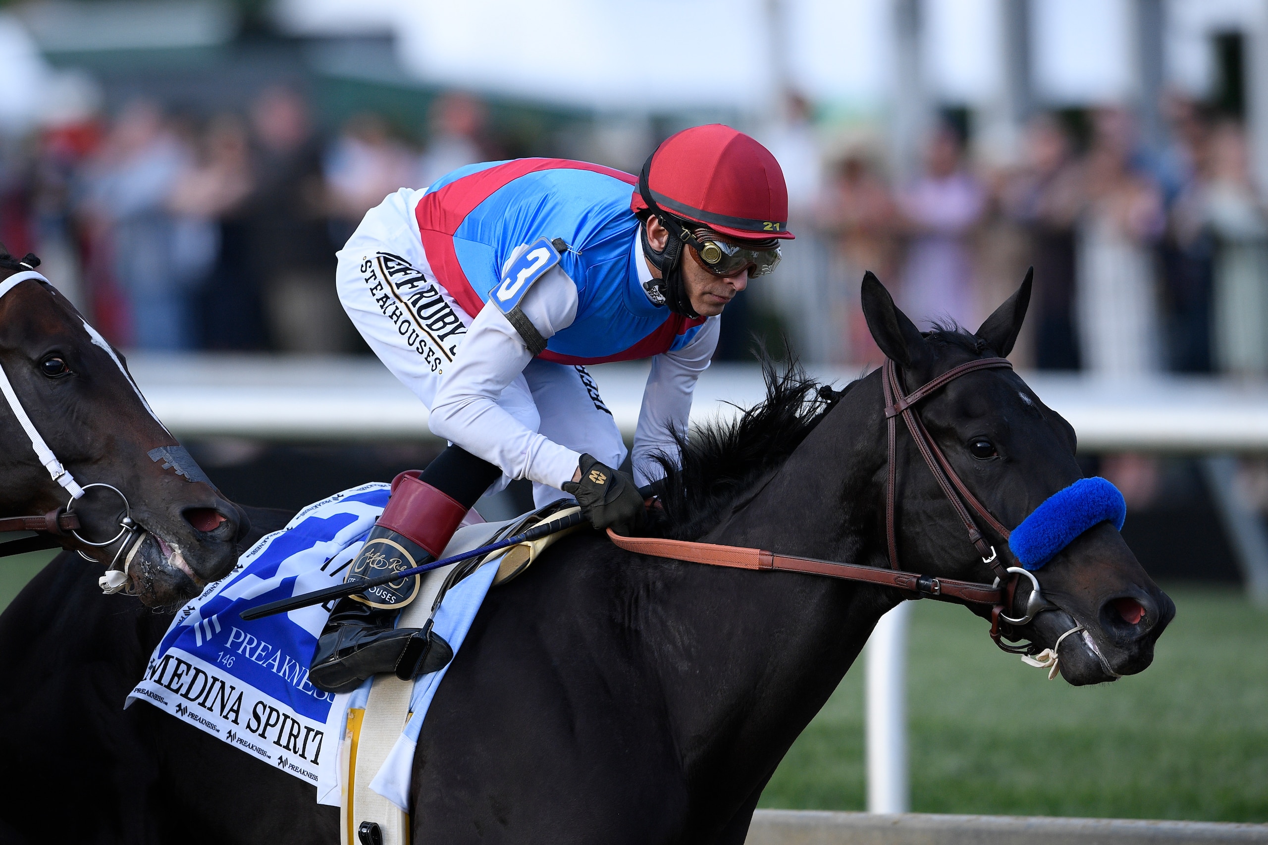 John Velazquez atop Medina Spirit runs in the Preakness Stakes horse race at Pimlico Race Course, Saturday, May 15, 2021, in Baltimore. (AP Photo/Nick Wass)