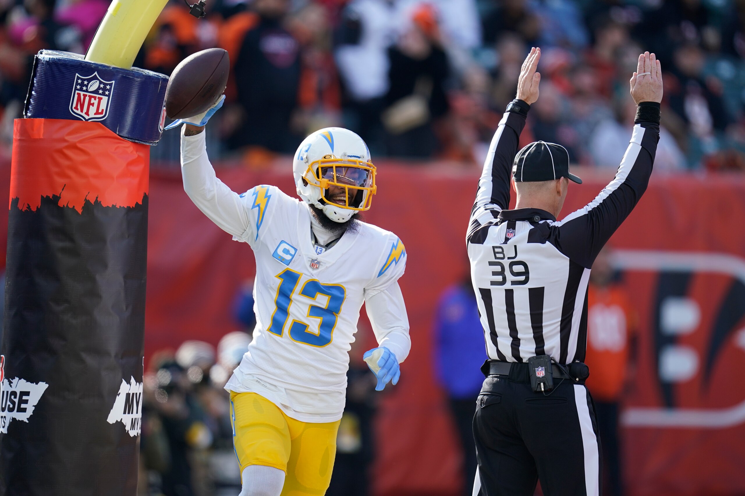 Los Angeles Chargers' Keenan Allen (13) reacts after a touchdown reception during the first half of an NFL football game against the Cincinnati Bengals, Sunday, Dec. 5, 2021, in Cincinnati. (AP Photo/Michael Conroy)
