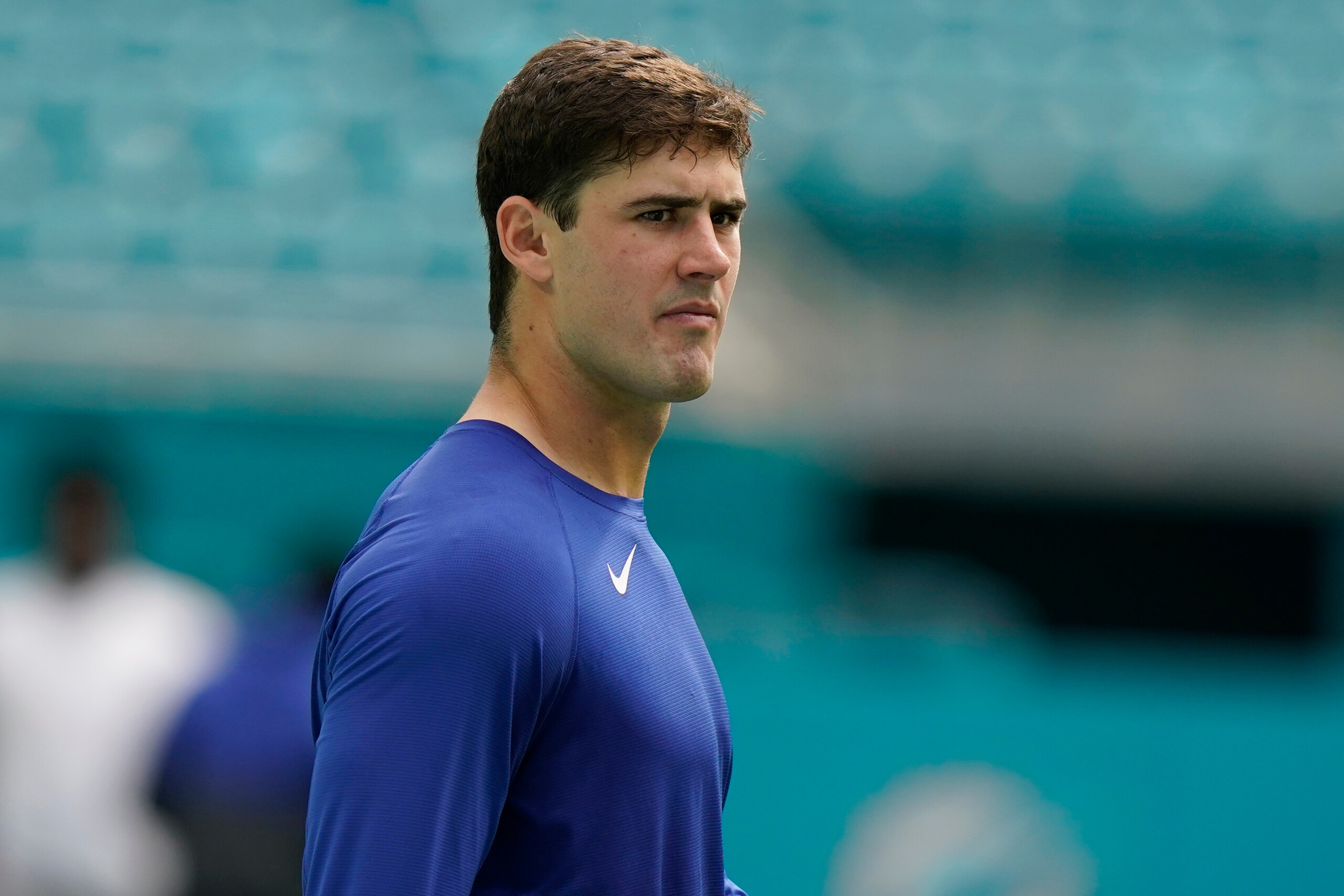 New York Giants quarterback Daniel Jones (8) walks the field before an NFL football game against the Miami Dolphins, Sunday, Dec. 5, 2021, in Miami Gardens, Fla. Jones is on the injured list. (AP Photo/Lynne Sladky)