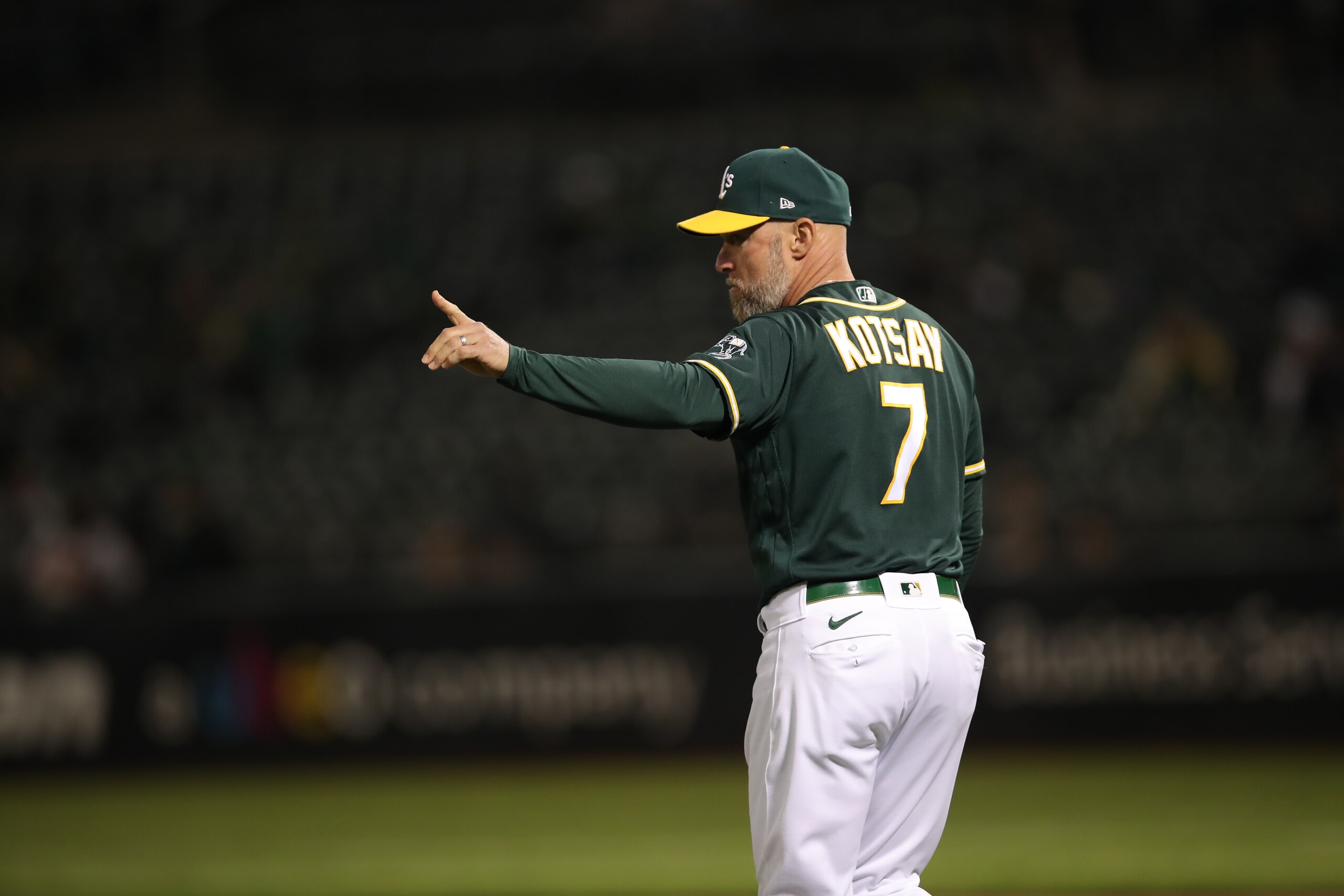 OAKLAND, CA - SEPTMEBER 22: Third Base Coach Mark Kotsay #7 of the Oakland Athletics makes a pitching change during the game against the Seattle Mariners at RingCentral Coliseum on September 22, 2021 in Oakland, California. The Mariners defeated the Athletics 4-1. (Photo by Michael Zagaris/Oakland Athletics/Getty Images) OAKLAND, CA - SEPTMEBER 22: Third Base Coach Mark Kotsay #7 of the Oakland Athletics makes a pitching change during the game against the Seattle Mariners at RingCentral Coliseum on September 22, 2021 in Oakland, California. The Mariners defeated the Athletics 4-1. (Photo by Michael Zagaris/Oakland Athletics/Getty Images)