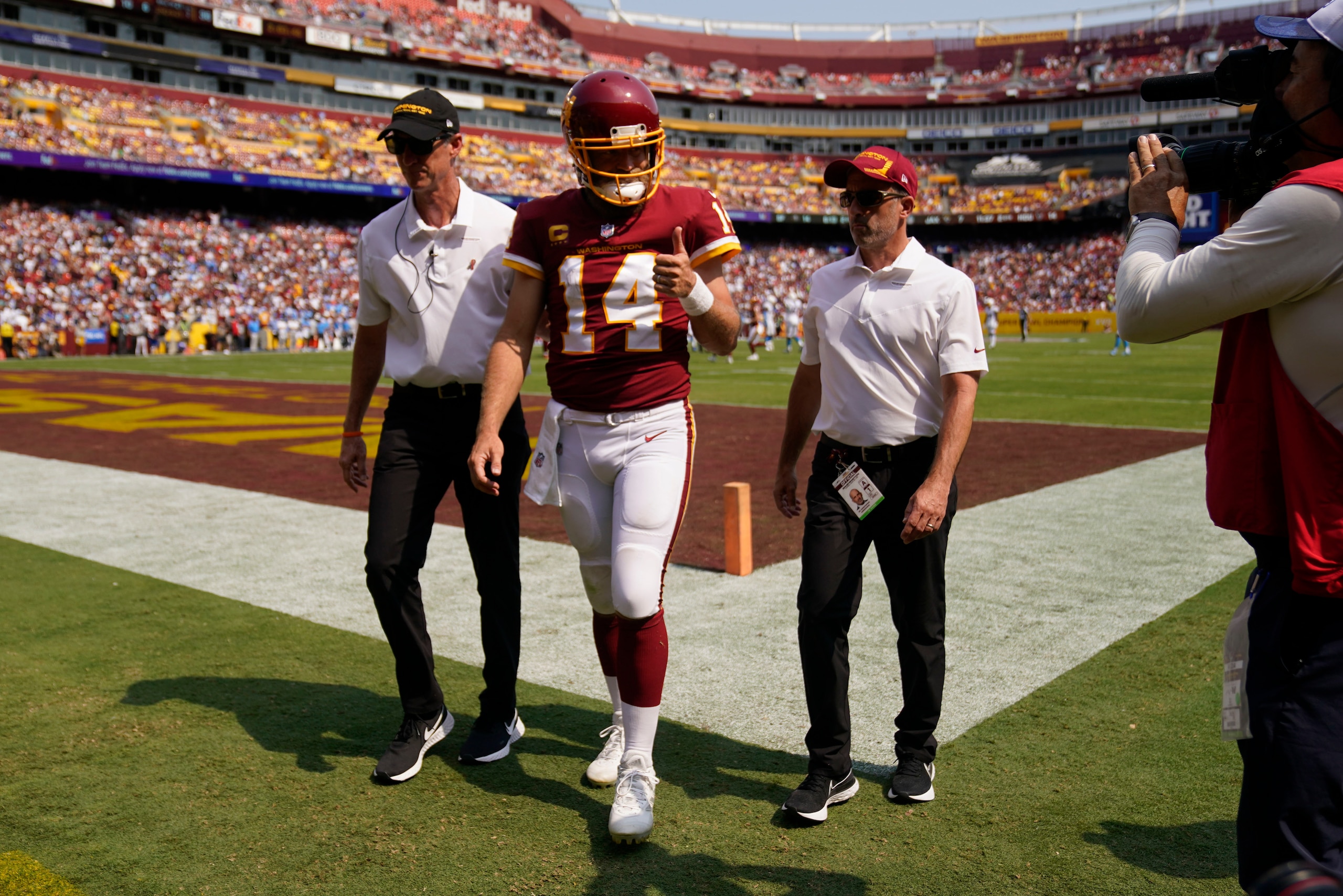 Washington Football Team quarterback Ryan Fitzpatrick (14) gives a 'thumbs-up' as he walks off field after being injured during the first half of an NFL football game against the Los Angeles Chargers, Sunday, Sept. 12, 2021, in Landover, Md. (AP Photo/Andrew Harnik)