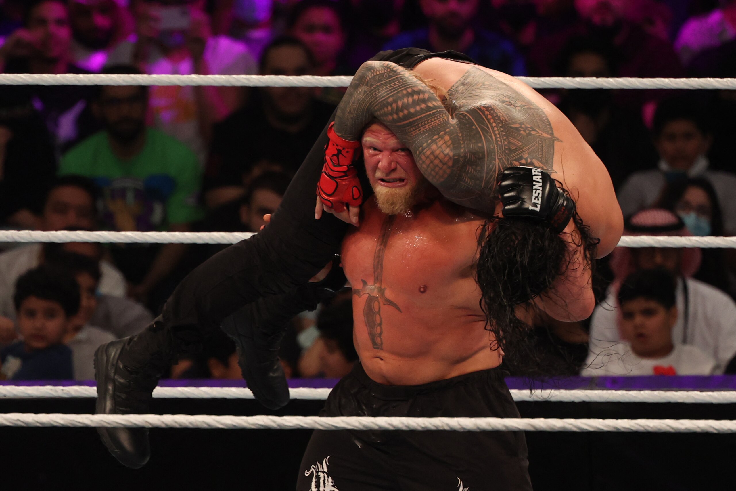 Roman Reigns competes with Brock Lesnar (L) during the World Wrestling Entertainment (WWE) Crown Jewel pay-per-view in the Saudi capital Riyadh on October 21, 2021. (Photo by Fayez Nureldine / AFP) (Photo by FAYEZ NURELDINE/AFP via Getty Images)