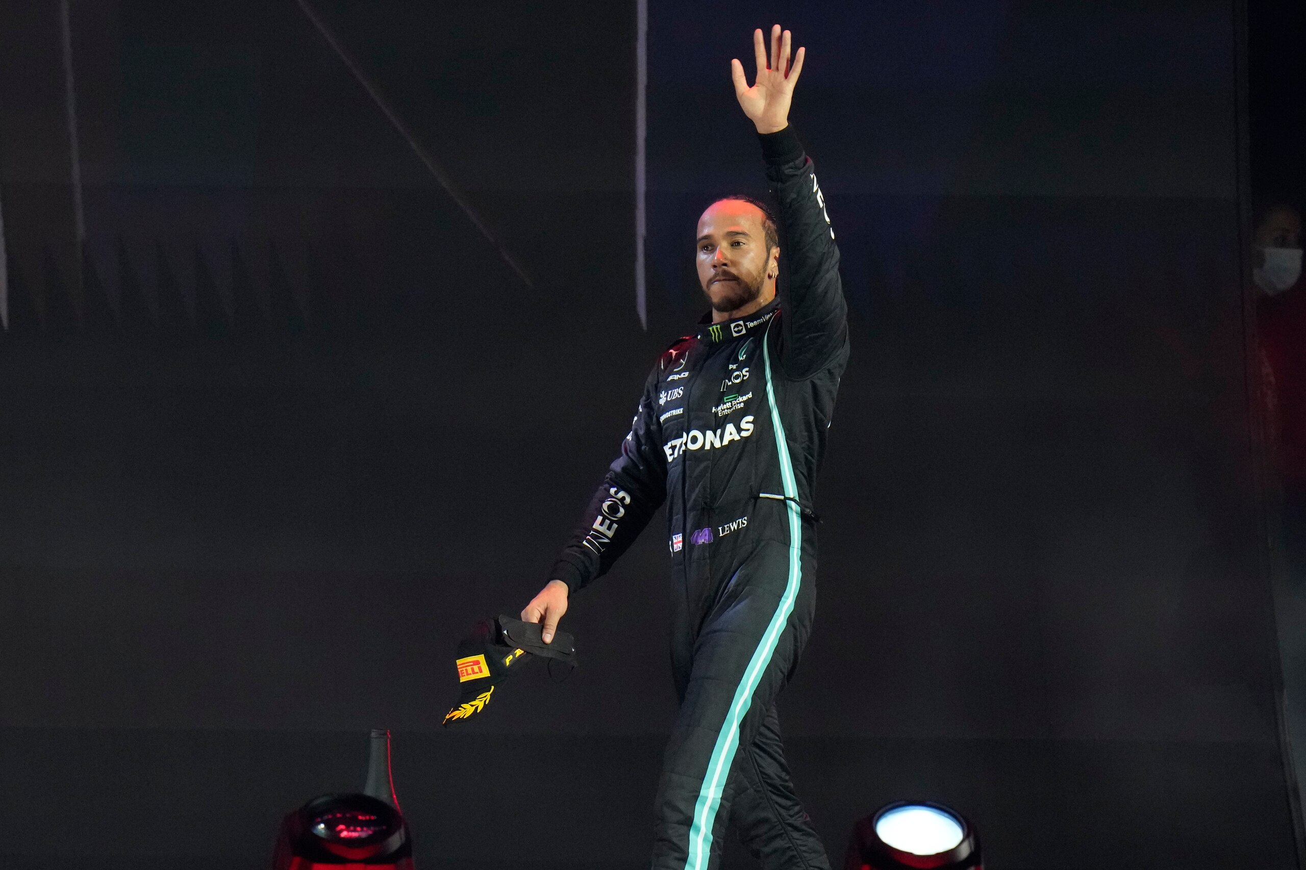 Mercedes driver Lewis Hamilton of Britain waves from the podium after winning the Formula One Saudi Arabian Grand Prix in Jiddah, Sunday, Dec. 5, 2021. (AP Photo/Hassan Ammar)