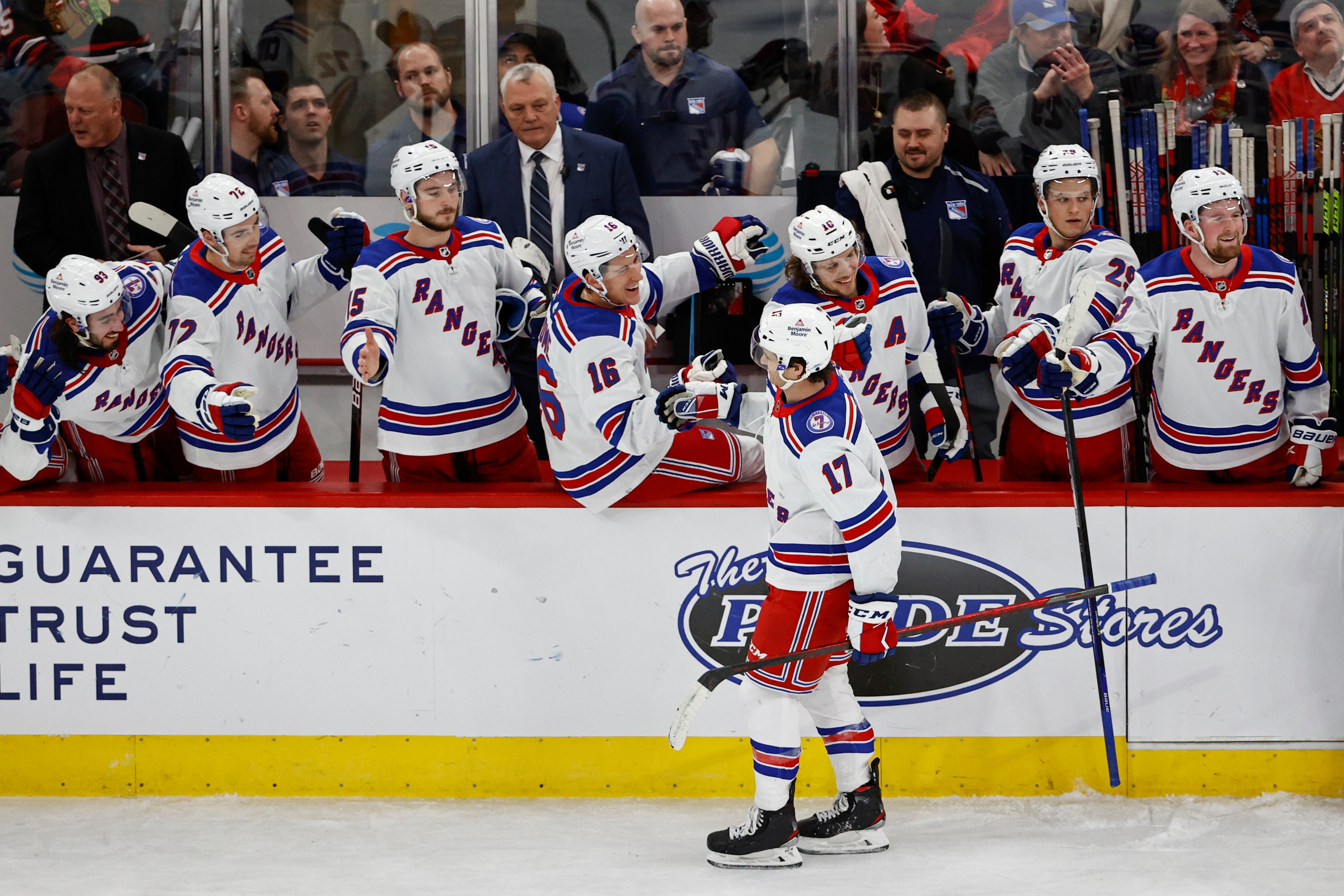 New York Rangers center Kevin Rooney (17) is congratulated by teammates after scoring against the Chicago Blackhawks during the third period of an NHL hockey game Tuesday, Dec. 7, 2021, in Chicago. (AP Photo/Kamil Krzaczynski)