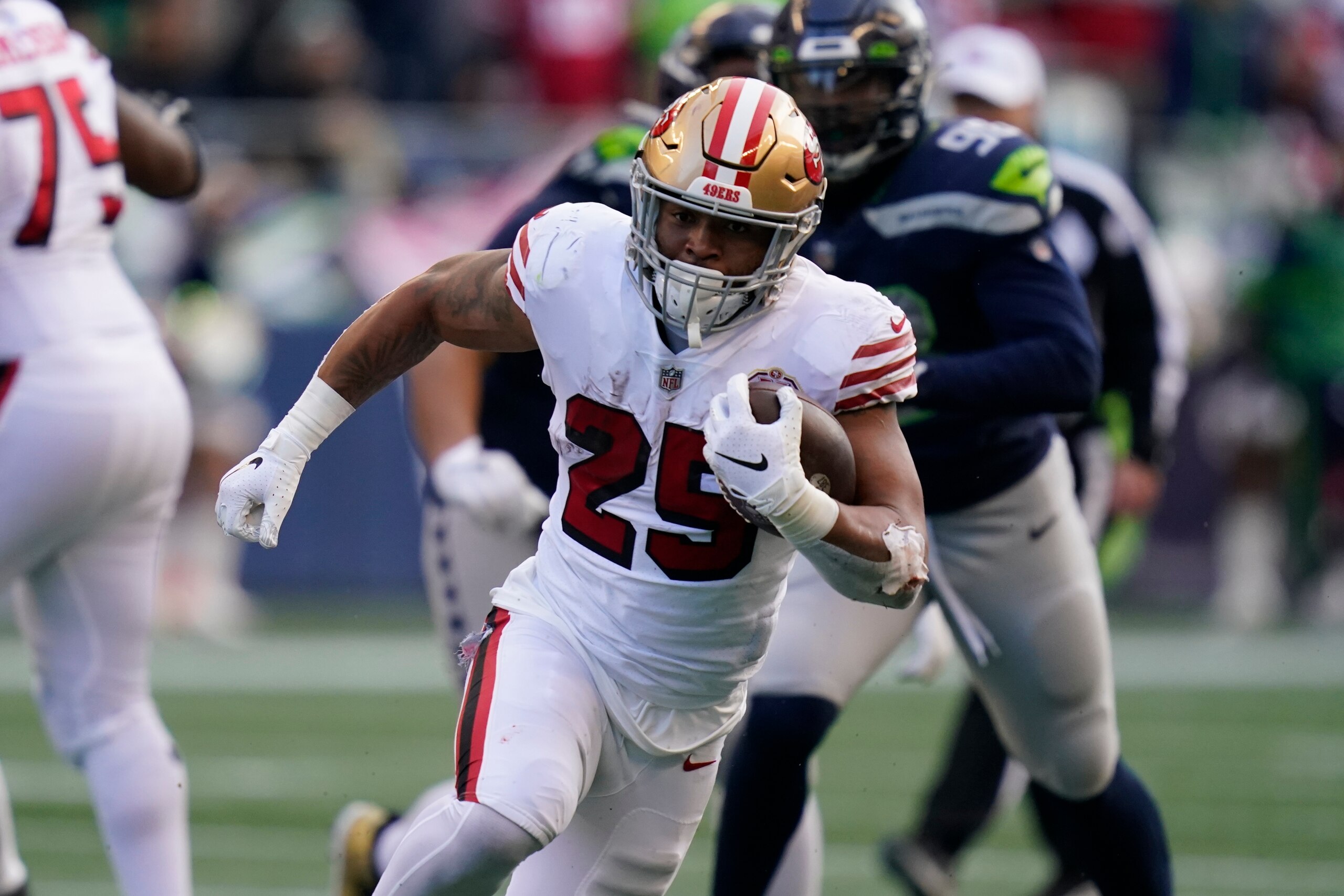 San Francisco 49ers running back Eli Mitchell in action against the Seattle Seahawks during the first half of an NFL football game, Sunday, Dec. 5, 2021, in Seattle. (AP Photo/Elaine Thompson)