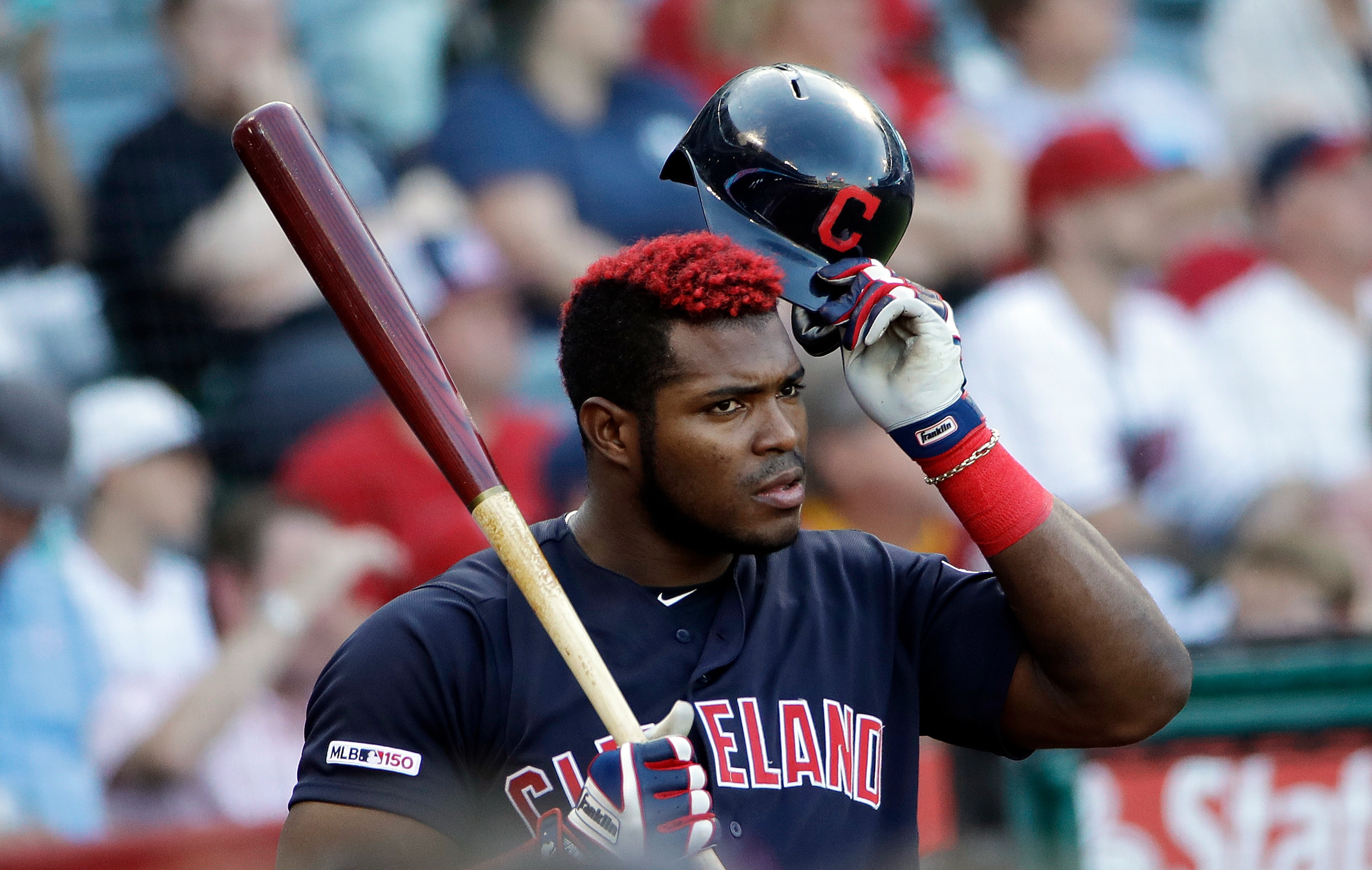 Cleveland Indians' Yasiel Puig waits for an at-bat during the first inning of a baseball game against the Los Angeles Angels Wednesday, Sept. 11, 2019, in Anaheim, Calif. (AP Photo/Marcio Jose Sanchez)