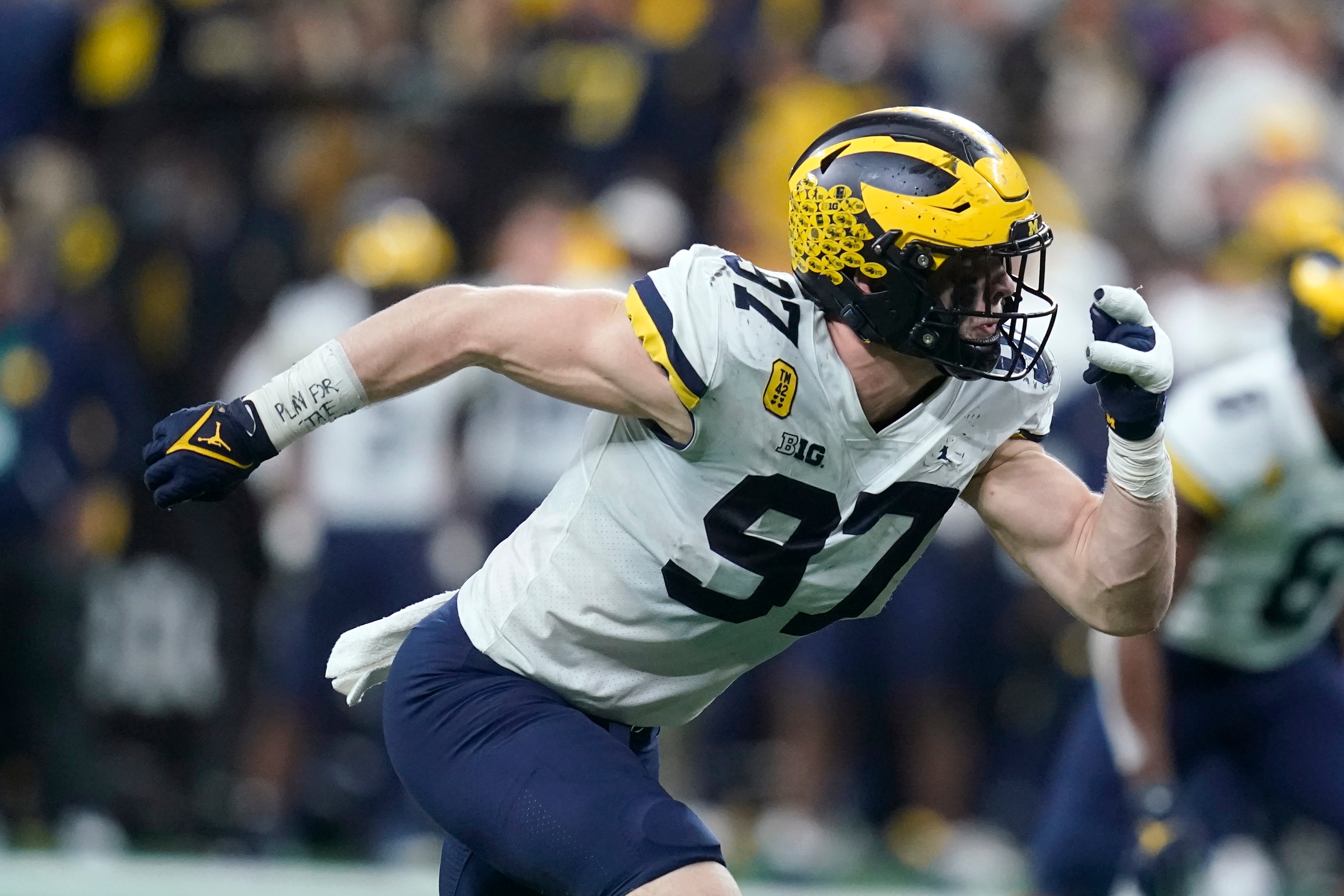 Michigan defensive end Aidan Hutchinson (97) rushes up field during the second half of the Big Ten championship NCAA college football game against Iowa, Saturday, Dec. 4, 2021, in Indianapolis. (AP Photo/Darron Cummings)