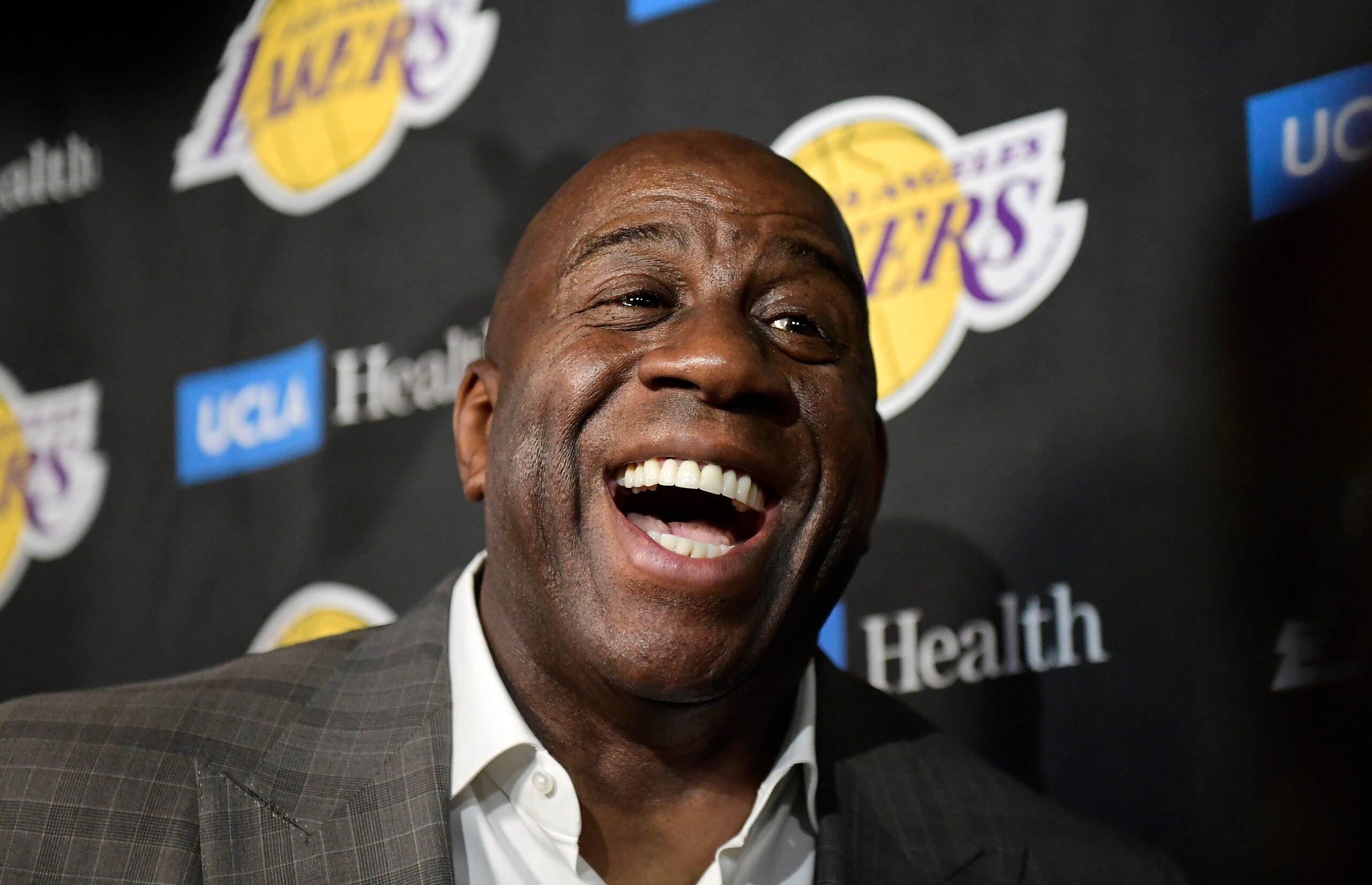 FILE - In this April 9, 2019, file photo, Magic Johnson speaks to reporters prior to an NBA basketball game between the Los Angeles Lakers and the Portland Trail Blazer in Los Angeles. Johnson might actually miss the Lakers if he was not always checking up on them. Johnson quit as the team's president of basketball operations at the end of the last season, leaving him out of a gym, but not out of the loop, as Los Angeles opened training camp. (AP Photo/Mark J. Terrill, File)