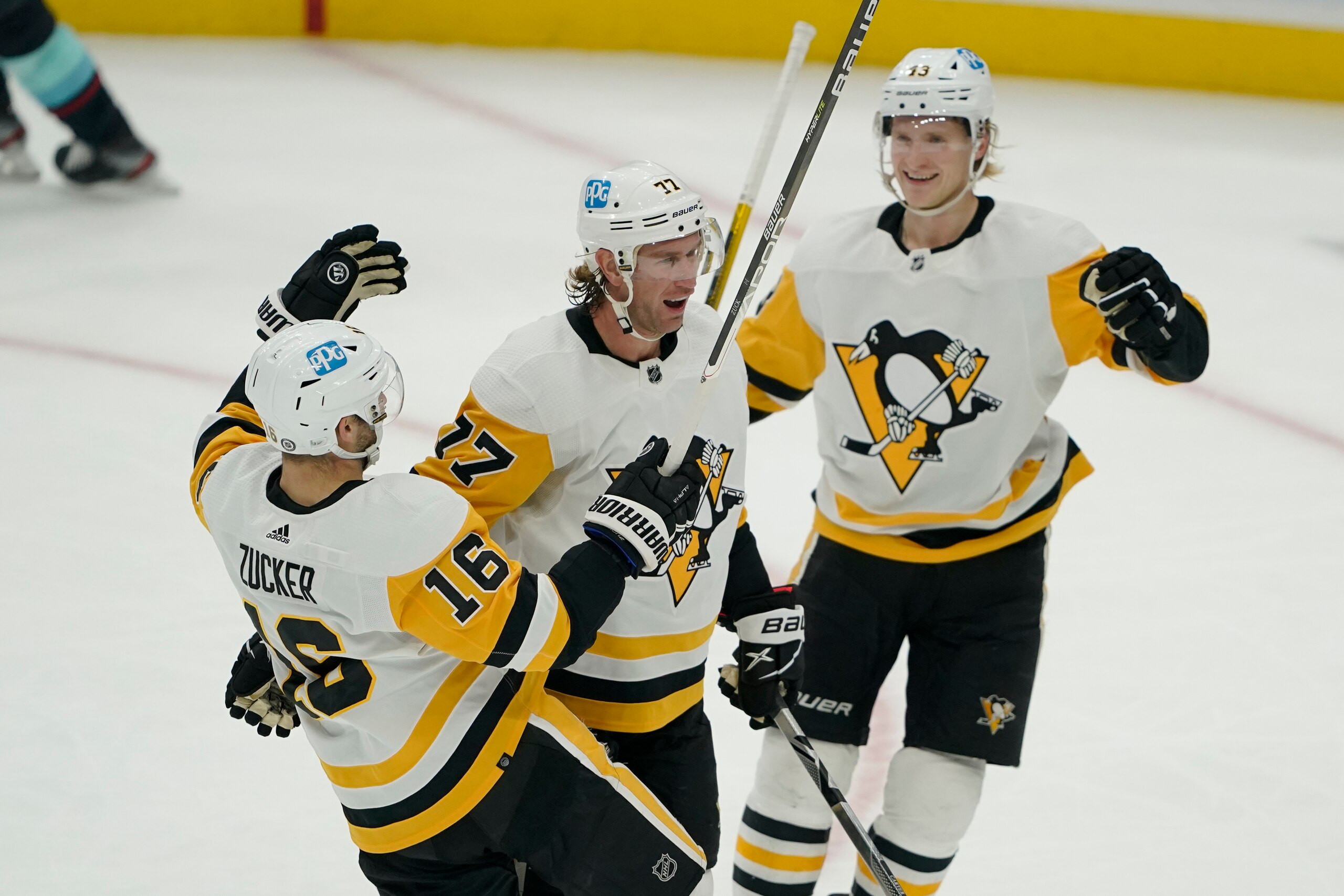 Pittsburgh Penguins center Jeff Carter, center, celebrates with teammates Jason Zucker (16) and Danton Heinen, right, after Carter scored a goal against the Seattle Kraken during the second period of an NHL hockey game, Monday, Dec. 6, 2021, in Seattle. (AP Photo/Ted S. Warren) Pittsburgh Penguins center Jeff Carter, center, celebrates with teammates Jason Zucker (16) and Danton Heinen, right, after Carter scored a goal against the Seattle Kraken during the second period of an NHL hockey game, Monday, Dec. 6, 2021, in Seattle. (AP Photo/Ted S. Warren)