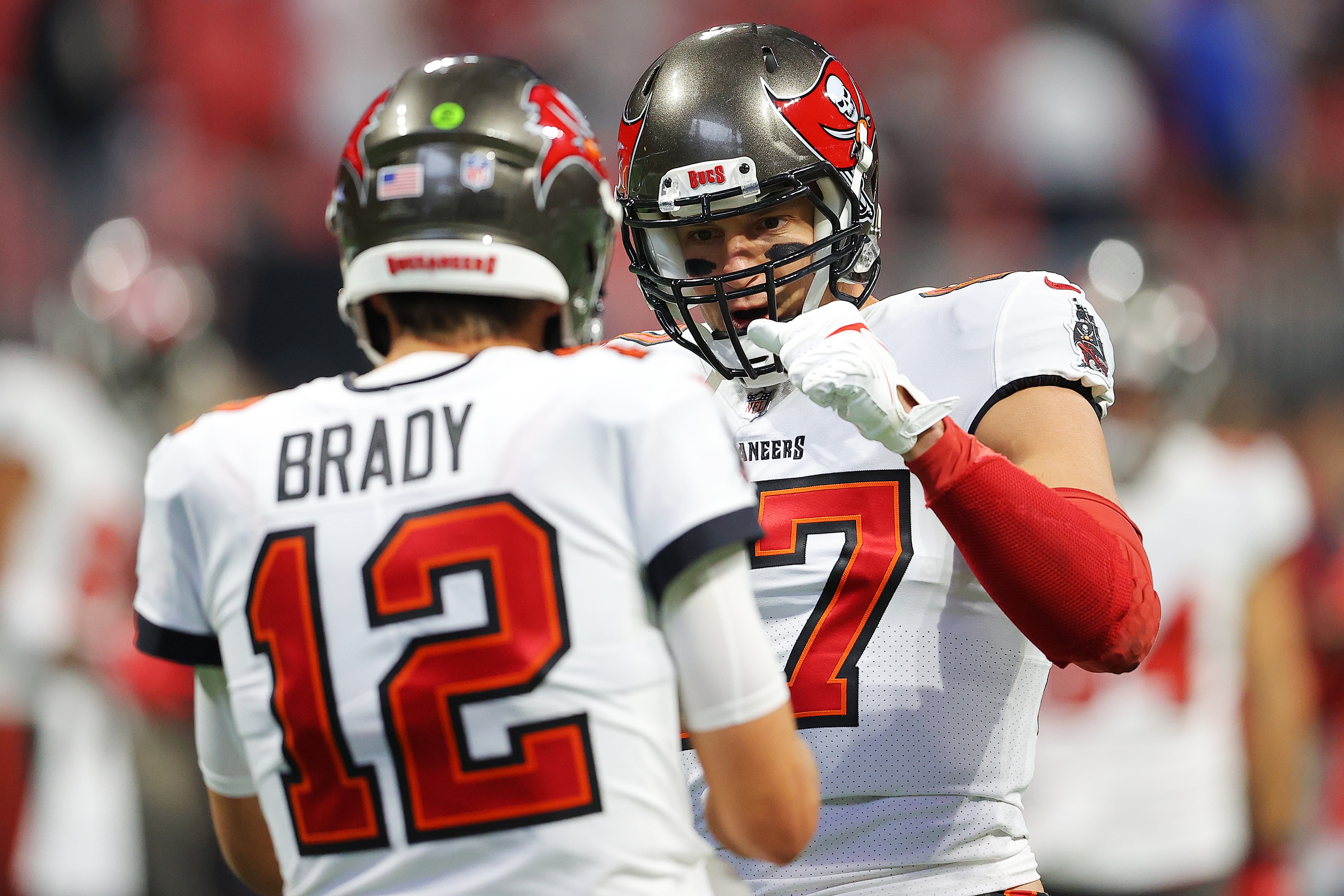 ATLANTA, GEORGIA - DECEMBER 05: Tom Brady #12 and Rob Gronkowski #87 of the Tampa Bay Buccaneers talk during pregame warm-ups prior to the game against the Atlanta Falcons at Mercedes-Benz Stadium on December 05, 2021 in Atlanta, Georgia. (Photo by Kevin C. Cox/Getty Images)