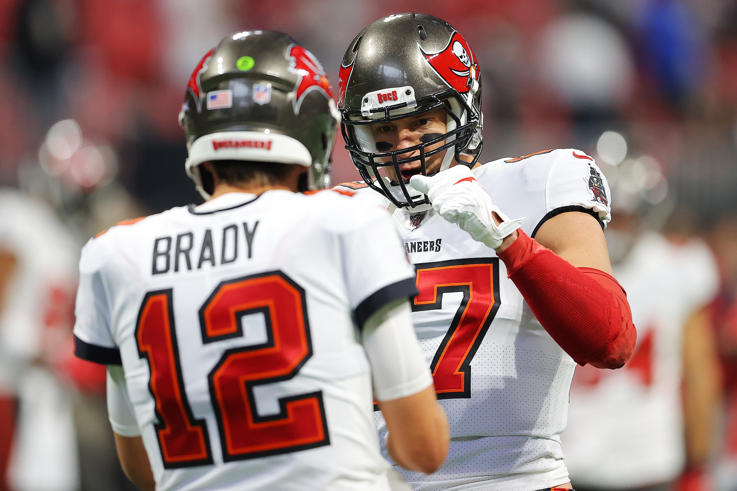 ATLANTA, GEORGIA - DECEMBER 05: Tom Brady #12 and Rob Gronkowski #87 of the Tampa Bay Buccaneers talk during pregame warm-ups prior to the game against the Atlanta Falcons at Mercedes-Benz Stadium on December 05, 2021 in Atlanta, Georgia. (Photo by Kevin C. Cox/Getty Images)