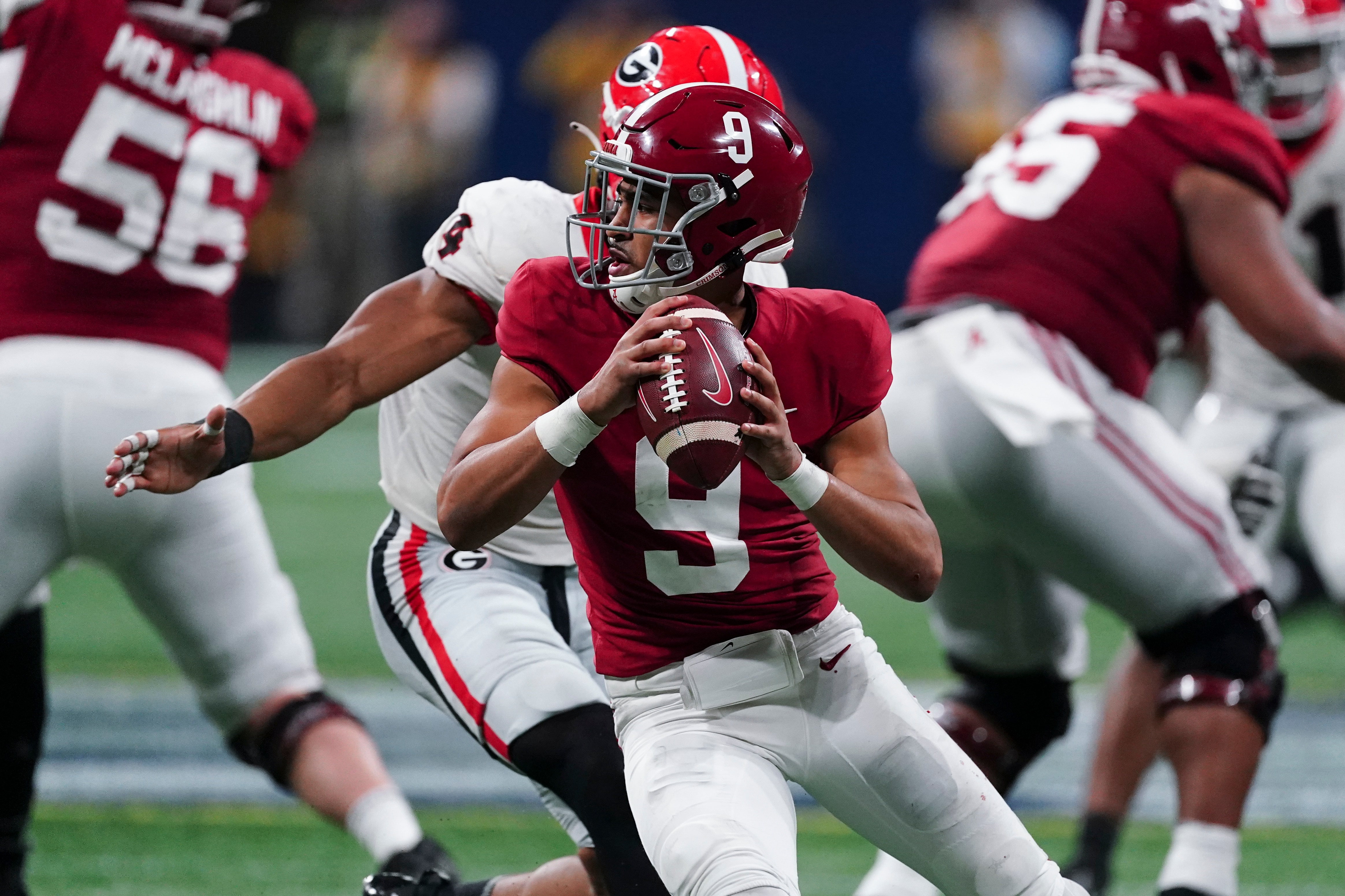 FILE - Alabama quarterback Bryce Young (9) works against Georgia during the second half of the Southeastern Conference championship NCAA college football game Dec. 4, 2021, in Atlanta. Young, Michigan defensive end Aidan Hutchinson, Pittsburgh quarterback Kenny Pickett and Ohio State quarterback C.J. Stroud are the finalists for the Heisman Trophy. (AP Photo/John Bazemore, File)