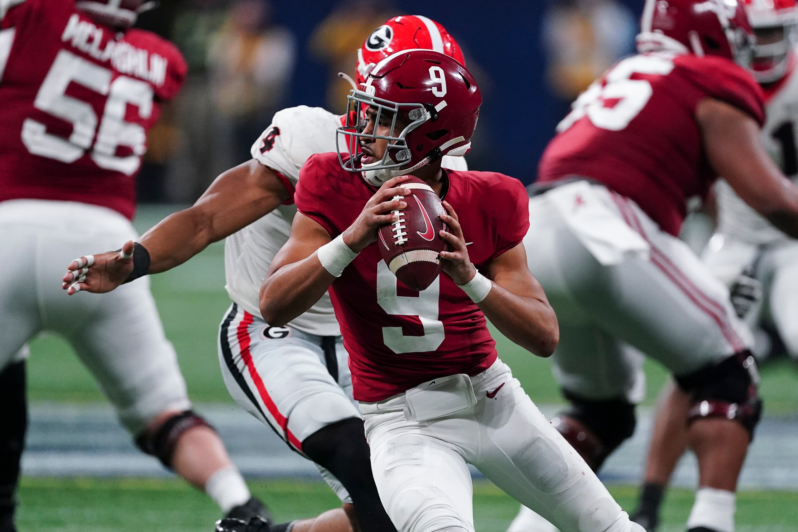FILE - Alabama quarterback Bryce Young (9) works against Georgia during the second half of the Southeastern Conference championship NCAA college football game Dec. 4, 2021, in Atlanta. Young, Michigan defensive end Aidan Hutchinson, Pittsburgh quarterback Kenny Pickett and Ohio State quarterback C.J. Stroud are the finalists for the Heisman Trophy. (AP Photo/John Bazemore, File)