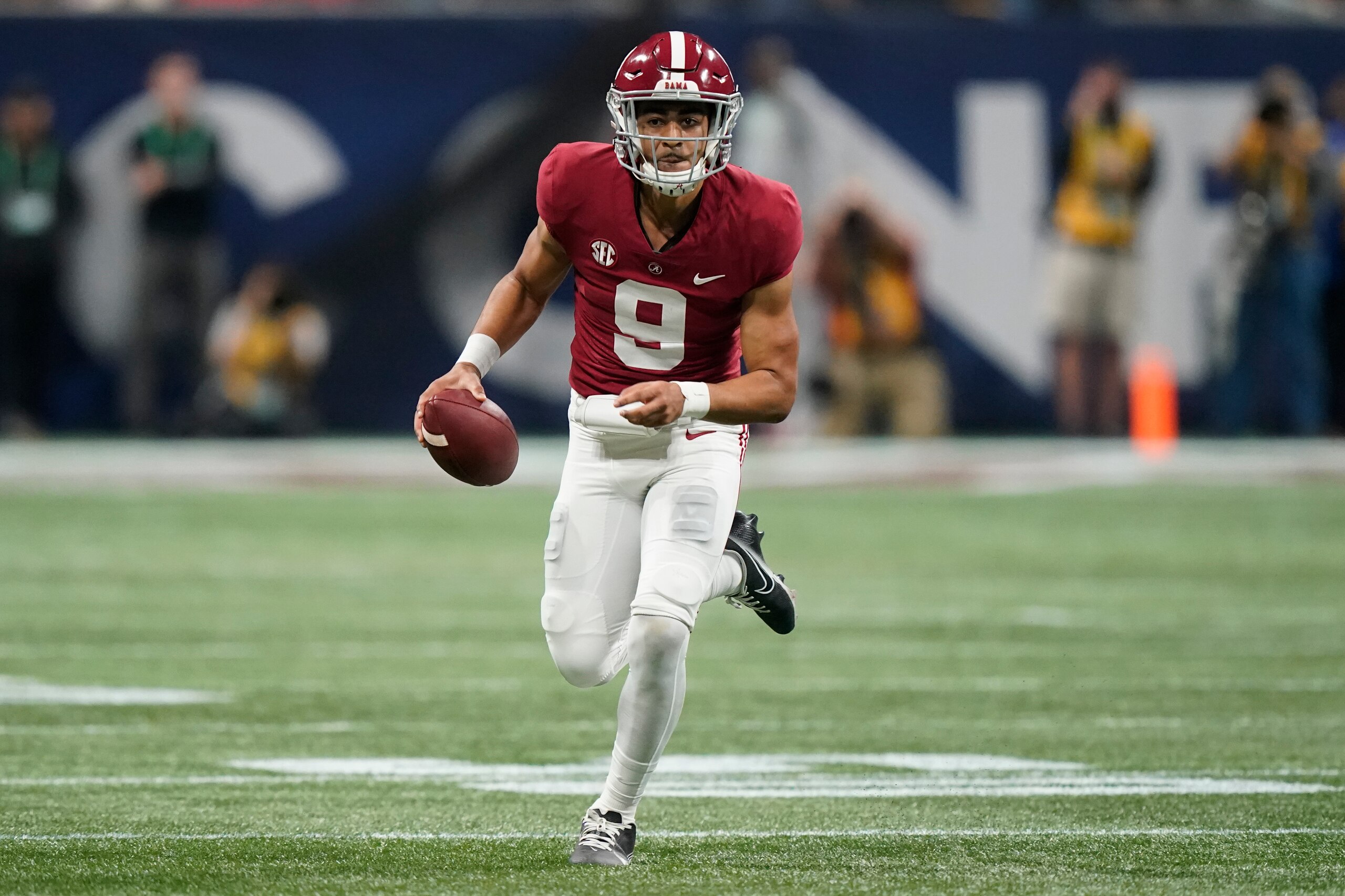 Alabama quarterback Bryce Young (9) runs against Georgia during the first half of the Southeastern Conference championship NCAA college football game, Saturday, Dec. 4, 2021, in Atlanta. (AP Photo/Brynn Anderson)