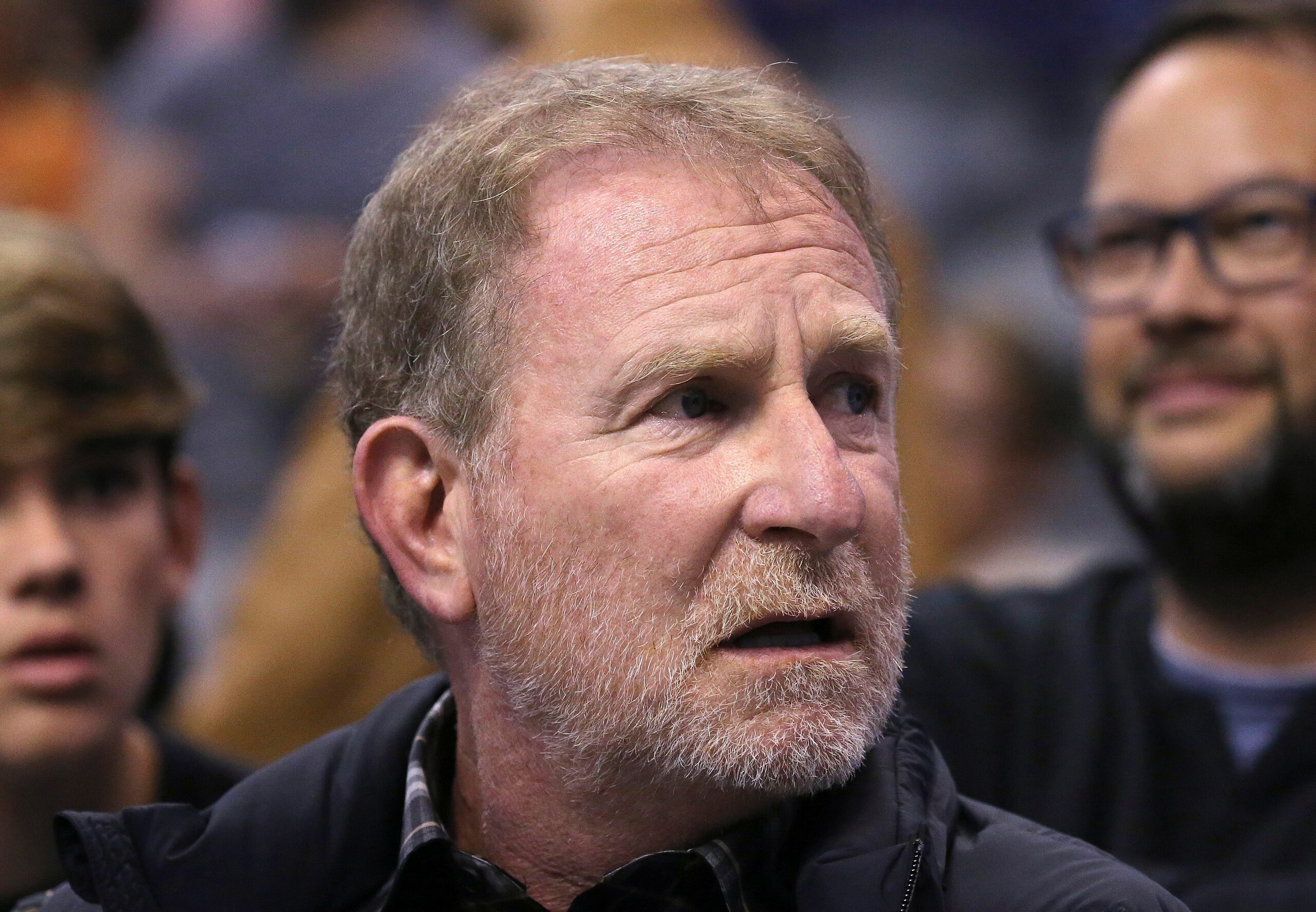 FILE - In this Dec. 11, 2019, file photo, Phoenix Suns owner Robert Sarver watches the team play against the Memphis Grizzlies during the second half of an NBA basketball game in Phoenix. The Suns released a statement regarding a potential media investigation into the workplace culture of the franchise, denying that the organization or Sarver has a history of racism or sexism. The statement sent Friday, Oct. 22, 2021, said the organization is aware that ESPN is working on a story accusing the organization of misconduct on a “variety of topics.” The Suns responded by saying they were “completely baseless claims” and “documentary evidence in our possession and eyewitness accounts directly contradict the reporter’s accusations, and we are preparing our response to his questions.” (AP Photo/Ross D. Franklin, File)