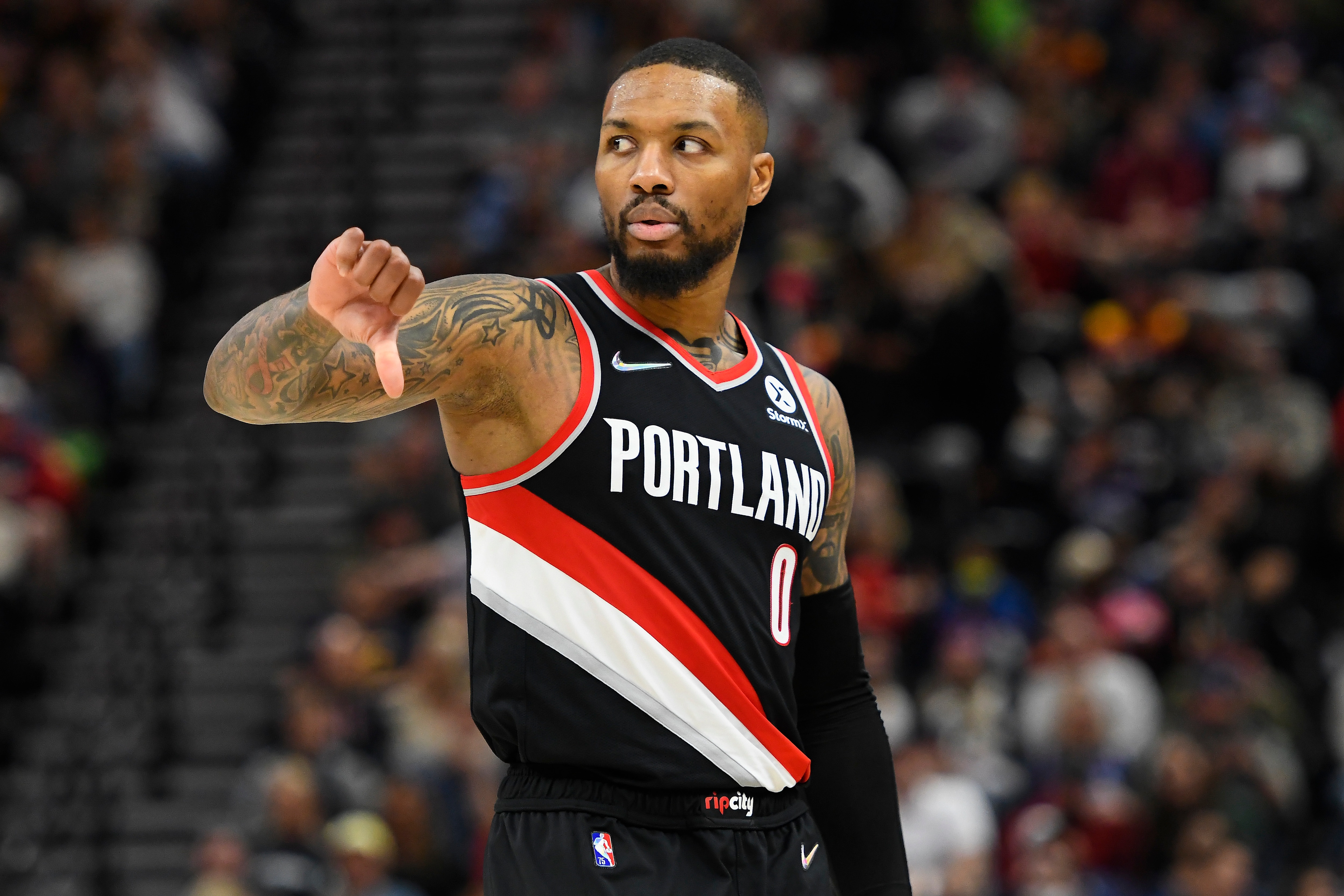 SALT LAKE CITY, UTAH - NOVEMBER 29: Damian Lillard #0 of the Portland Trail Blazers motions on the court in the second half during a game against the Utah Jazz at Vivint Smart Home Arena on November 29, 2021 in Salt Lake City, Utah. NOTE TO USER: User expressly acknowledges and agrees that, by downloading and or using this photograph, User is consenting to the terms and conditions of the Getty Images License Agreement.  (Photo by Alex Goodlett/Getty Images)