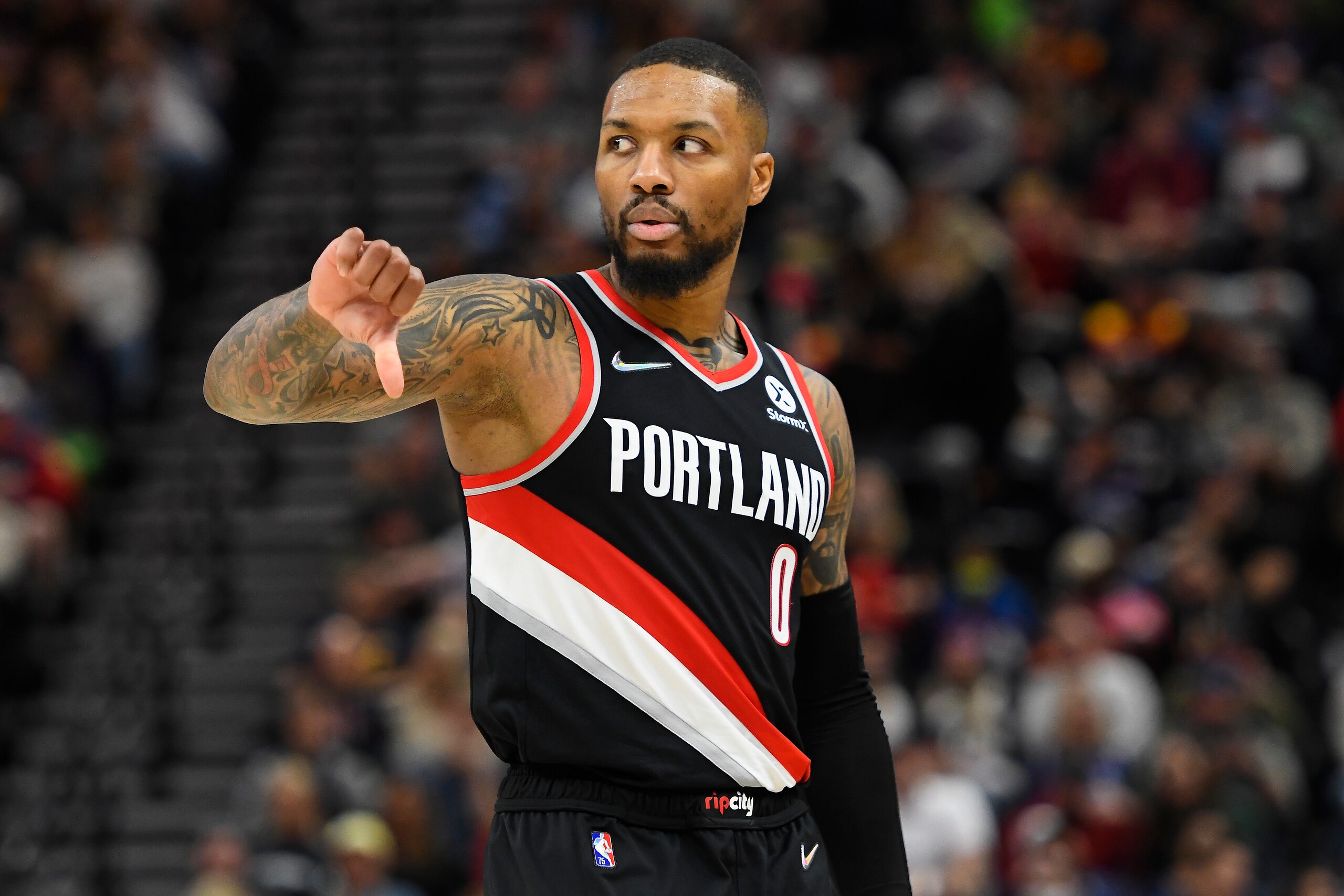 SALT LAKE CITY, UTAH - NOVEMBER 29: Damian Lillard #0 of the Portland Trail Blazers motions on the court in the second half during a game against the Utah Jazz at Vivint Smart Home Arena on November 29, 2021 in Salt Lake City, Utah. NOTE TO USER: User expressly acknowledges and agrees that, by downloading and or using this photograph, User is consenting to the terms and conditions of the Getty Images License Agreement.  (Photo by Alex Goodlett/Getty Images)