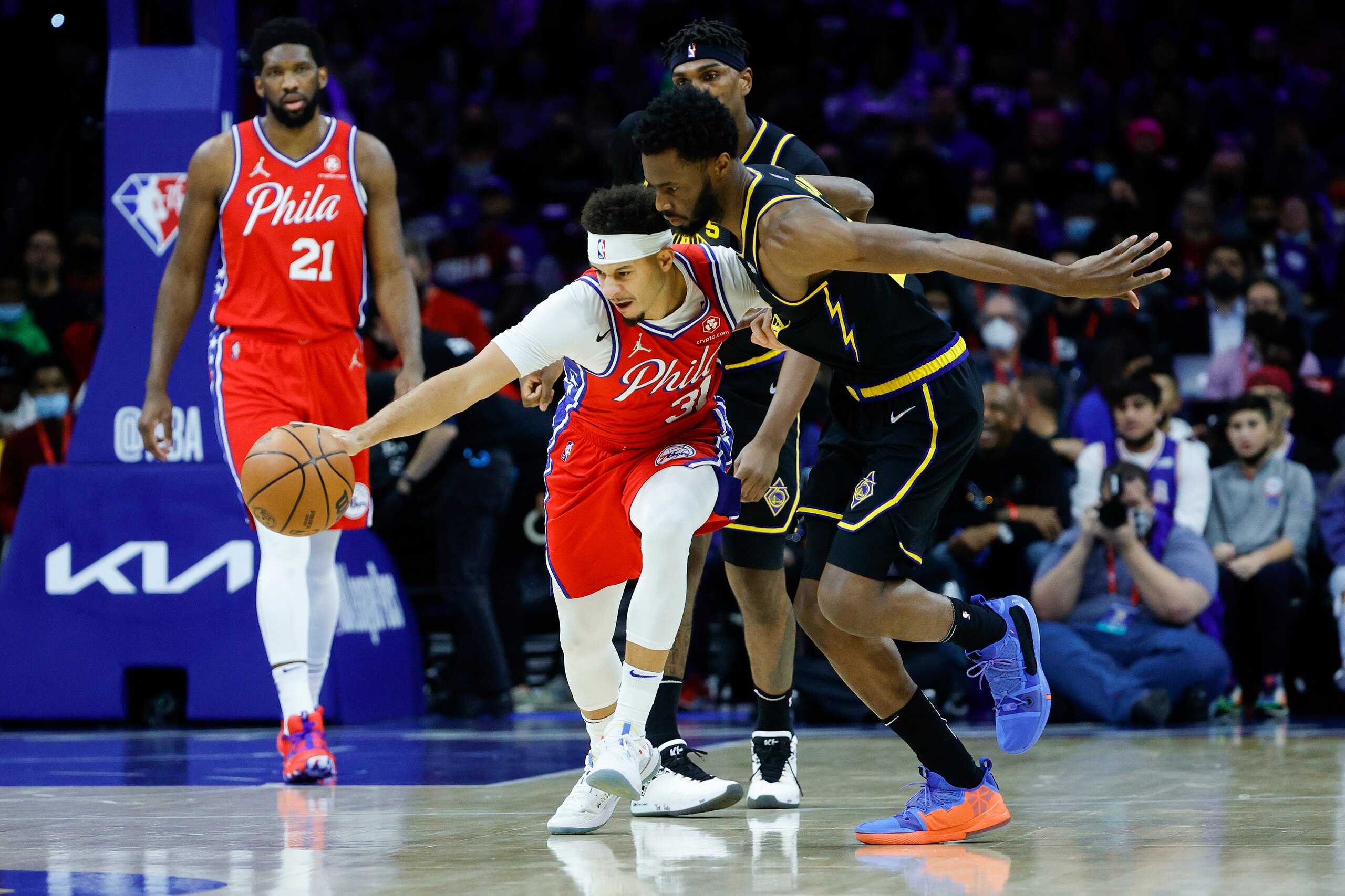 PHILADELPHIA, PENNSYLVANIA - DECEMBER 11: Seth Curry #31 of the Philadelphia 76ers steals the ball from Andrew Wiggins #22 of the Golden State Warriors during the first quarter at Wells Fargo Center on December 11, 2021 in Philadelphia, Pennsylvania. NOTE TO USER: User expressly acknowledges and agrees that, by downloading and or using this photograph, User is consenting to the terms and conditions of the Getty Images License Agreement. (Photo by Tim Nwachukwu/Getty Images)