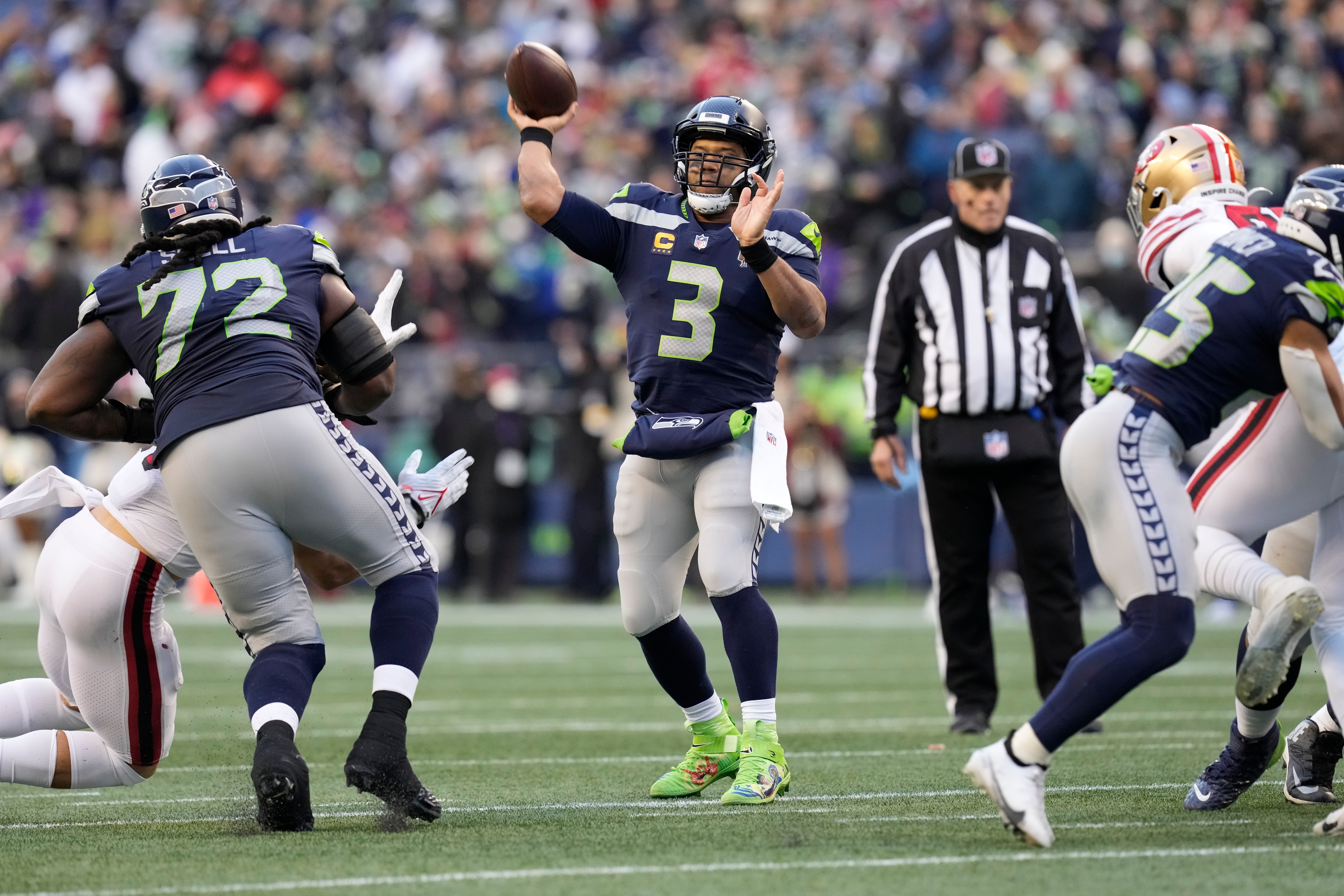 Seattle Seahawks quarterback Russell Wilson throws for a touchdown during an NFL football game against the San Francisco 49ers, Sunday, Dec. 5, 2021, in Seattle. The Seahawks won 30-23. (AP Photo/Ben VanHouten)