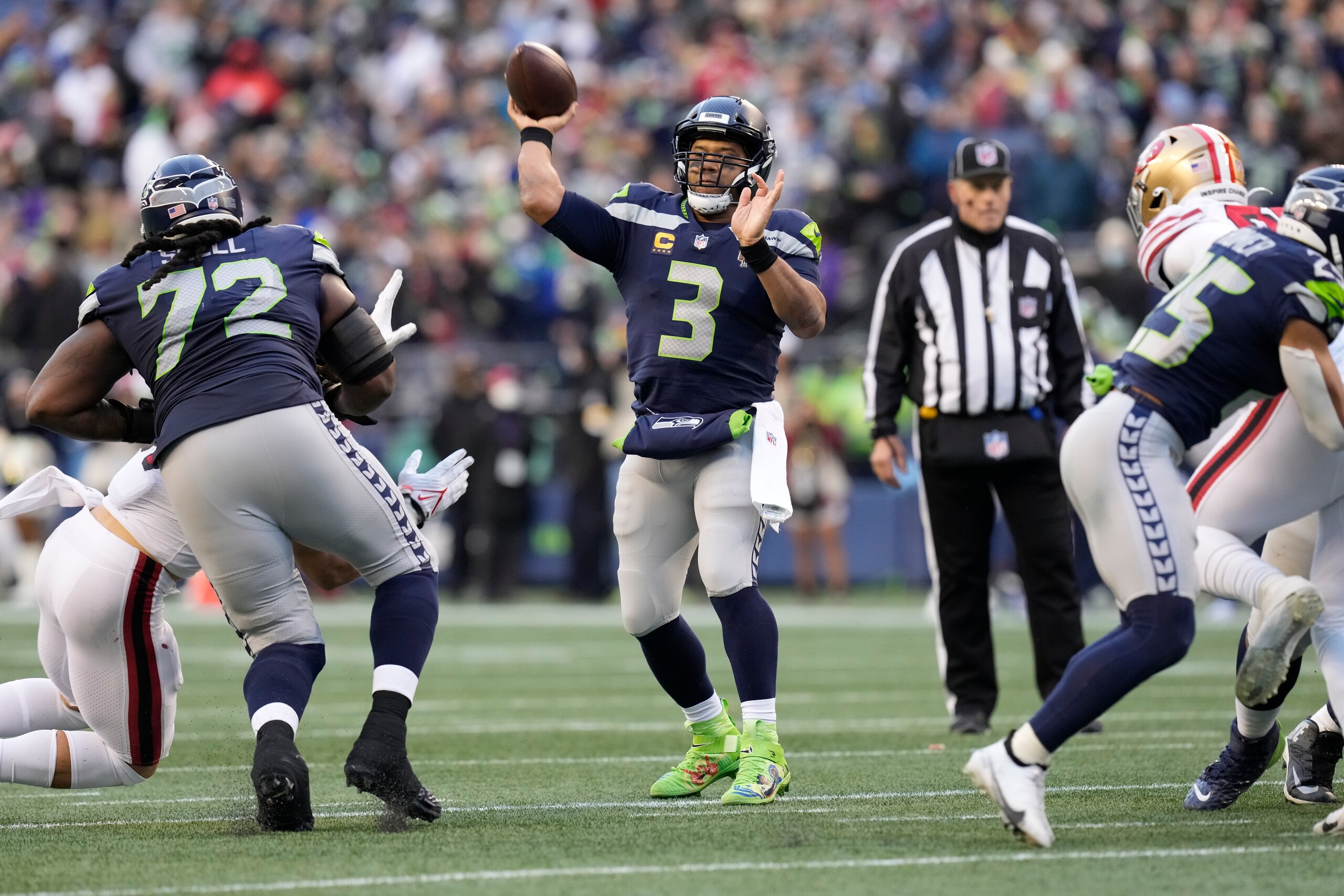 Seattle Seahawks quarterback Russell Wilson throws for a touchdown during an NFL football game against the San Francisco 49ers, Sunday, Dec. 5, 2021, in Seattle. The Seahawks won 30-23. (AP Photo/Ben VanHouten)