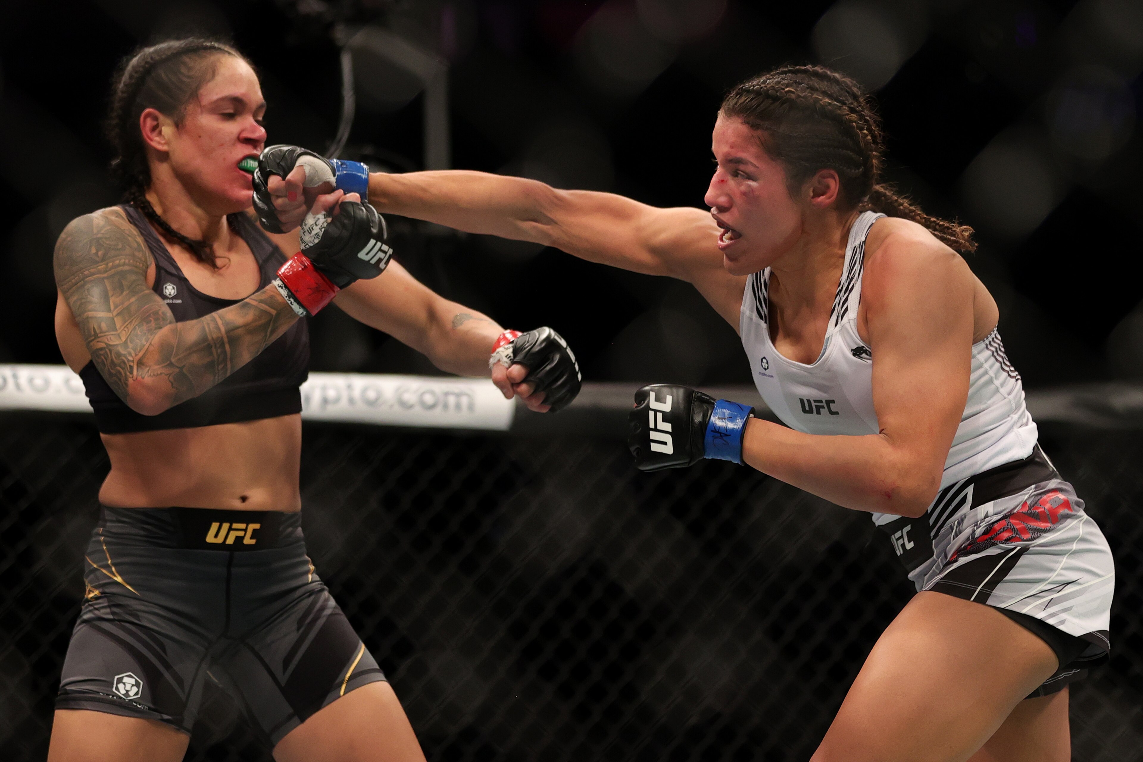 LAS VEGAS, NEVADA - DECEMBER 11: Julianna Pena (R) punches Amanda Nunes of Brazil in their women's bantamweight title fight during the UFC 269 event at T-Mobile Arena on December 11, 2021 in Las Vegas, Nevada. (Photo by Carmen Mandato/Getty Images) LAS VEGAS, NEVADA - DECEMBER 11: Julianna Pena (R) punches Amanda Nunes of Brazil in their women's bantamweight title fight during the UFC 269 event at T-Mobile Arena on December 11, 2021 in Las Vegas, Nevada. (Photo by Carmen Mandato/Getty Images)