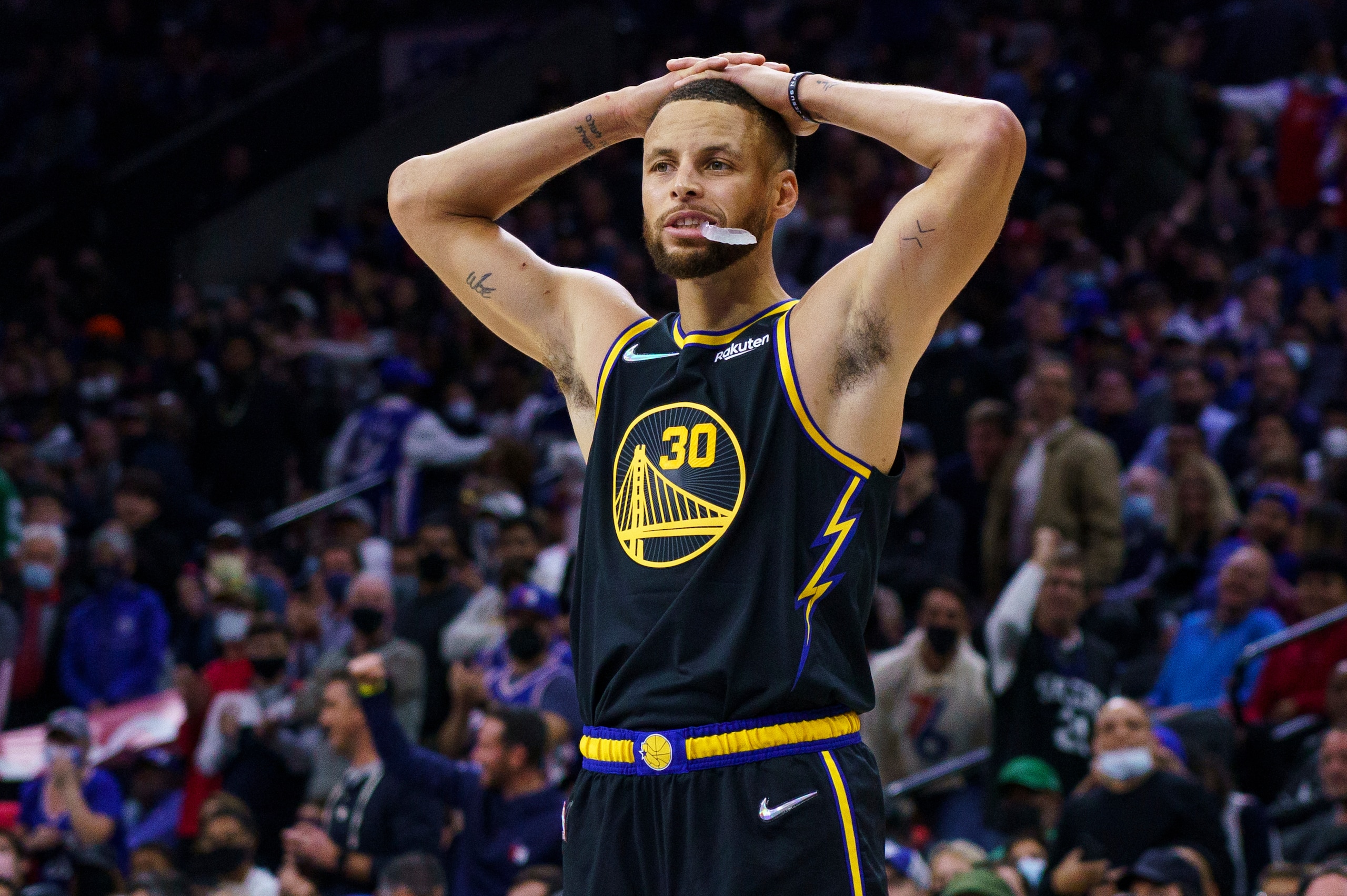 Golden State Warriors' Stephen Curry puts his hands on his head during the second half of an NBA basketball game against the Philadelphia 76ers, Saturday, Dec. 11, 2021, in Philadelphia. (AP Photo/Chris Szagola)