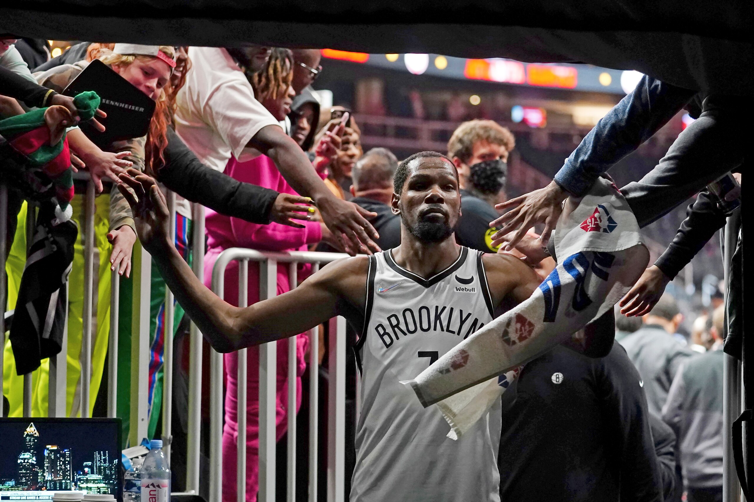 Brooklyn Nets forward Kevin Durant (7) makes his way past fans as he walks to the locker room after the Nets defeated the Atlanta Hawks in an NBA basketball game Friday, Dec. 10, 2021, in Atlanta. (AP Photo/John Bazemore)
