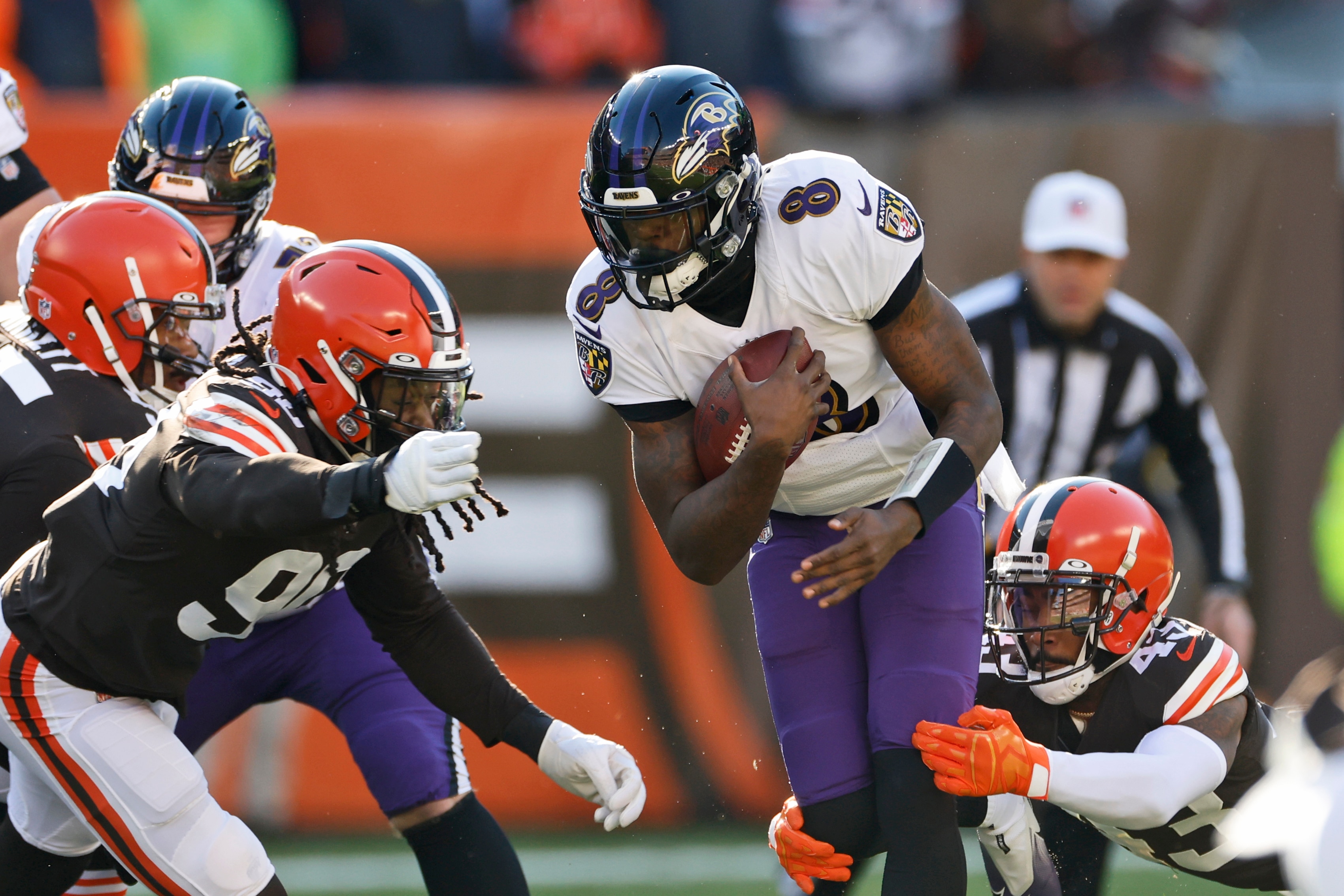 Baltimore Ravens quarterback Lamar Jackson (8) rushes during the first half of an NFL football game against the Cleveland Browns, Sunday, Dec. 12, 2021, in Cleveland. (AP Photo/Ron Schwane)
