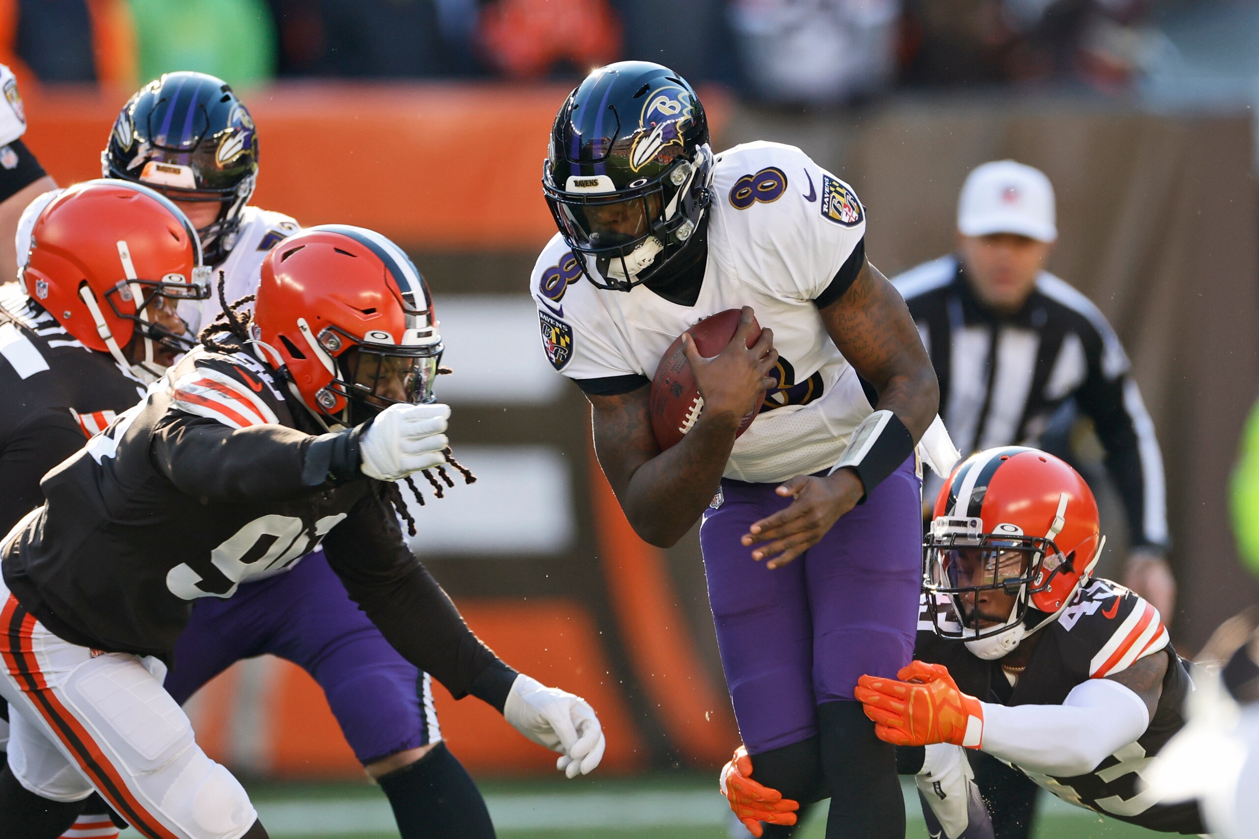 Baltimore Ravens quarterback Lamar Jackson (8) rushes during the first half of an NFL football game against the Cleveland Browns, Sunday, Dec. 12, 2021, in Cleveland. (AP Photo/Ron Schwane)