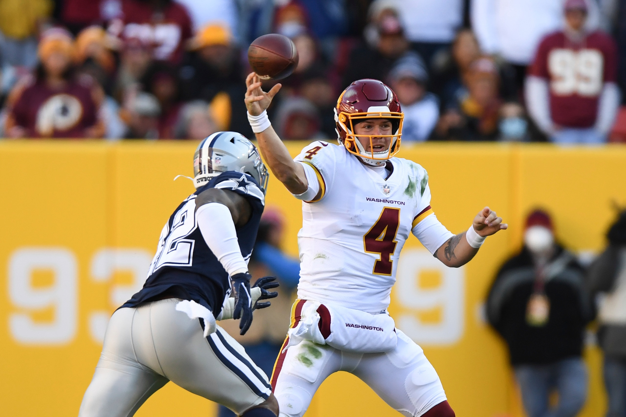 Washington Football Team quarterback Taylor Heinicke (4) throws the ball against Dallas Cowboys linebacker Keanu Neal during the second quarter of an NFL football game, Sunday, Dec. 12, 2021, in Landover, Md. (AP Photo/Terrance Williams)