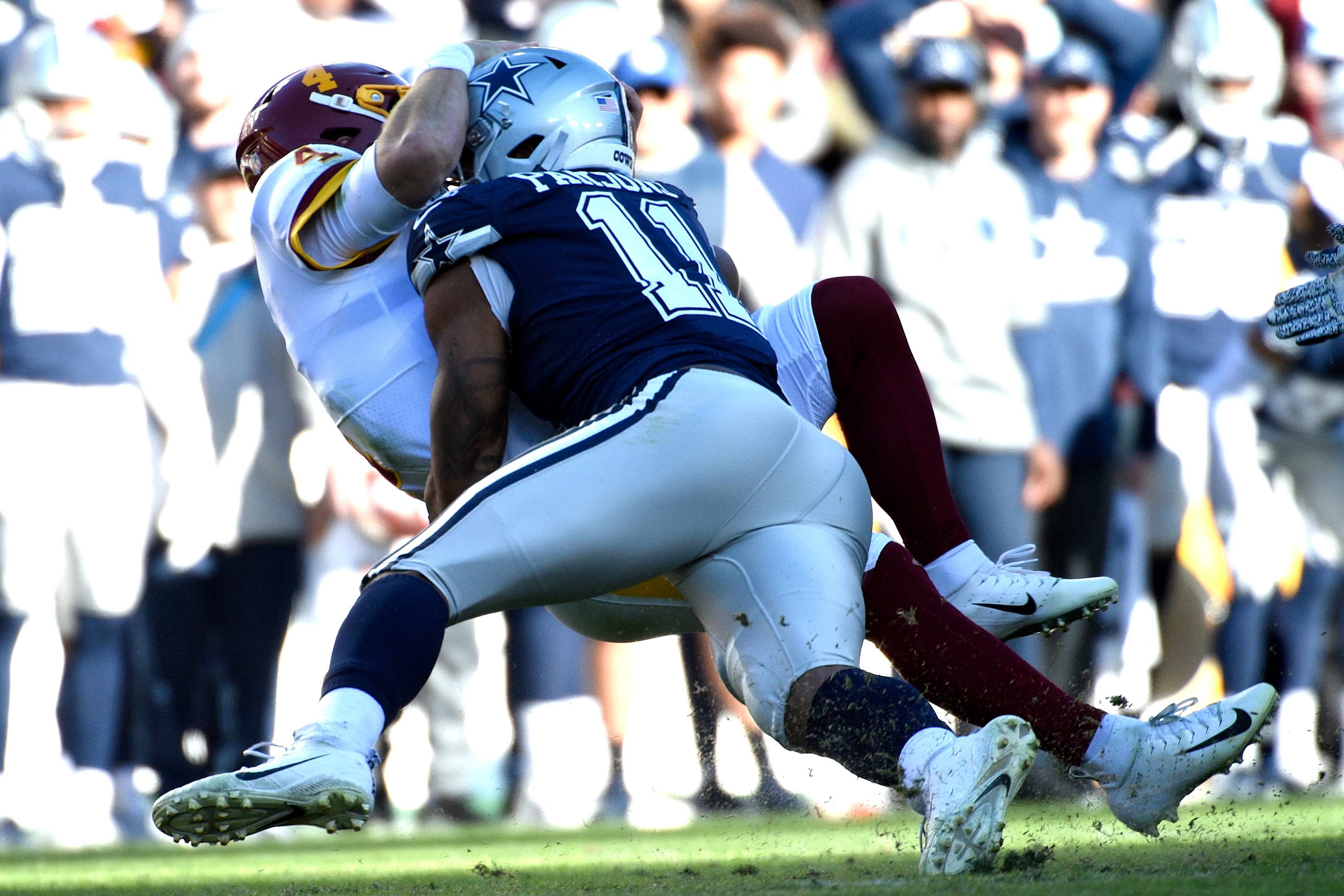 Washington Football Team quarterback Taylor Heinicke (4) is sacked by Dallas Cowboys outside linebacker Micah Parsons (11) during an NFL football game against the Dallas Cowboys, Sunday, Dec. 12, 2021, in Landover, Md. (AP Photo/Mark Tenally)