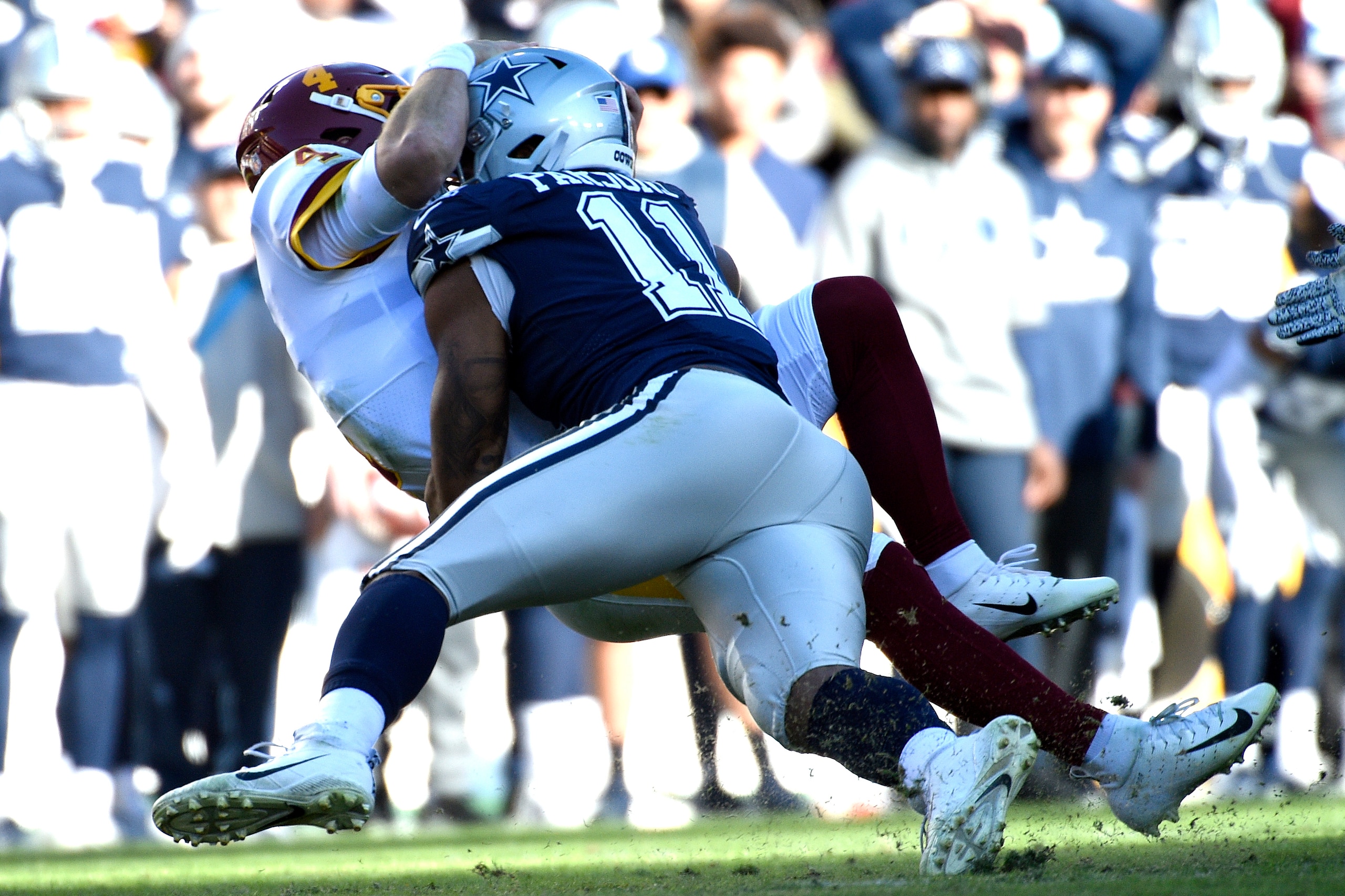Washington Football Team quarterback Taylor Heinicke (4) is sacked by Dallas Cowboys outside linebacker Micah Parsons (11) during an NFL football game against the Dallas Cowboys, Sunday, Dec. 12, 2021, in Landover, Md. (AP Photo/Mark Tenally)