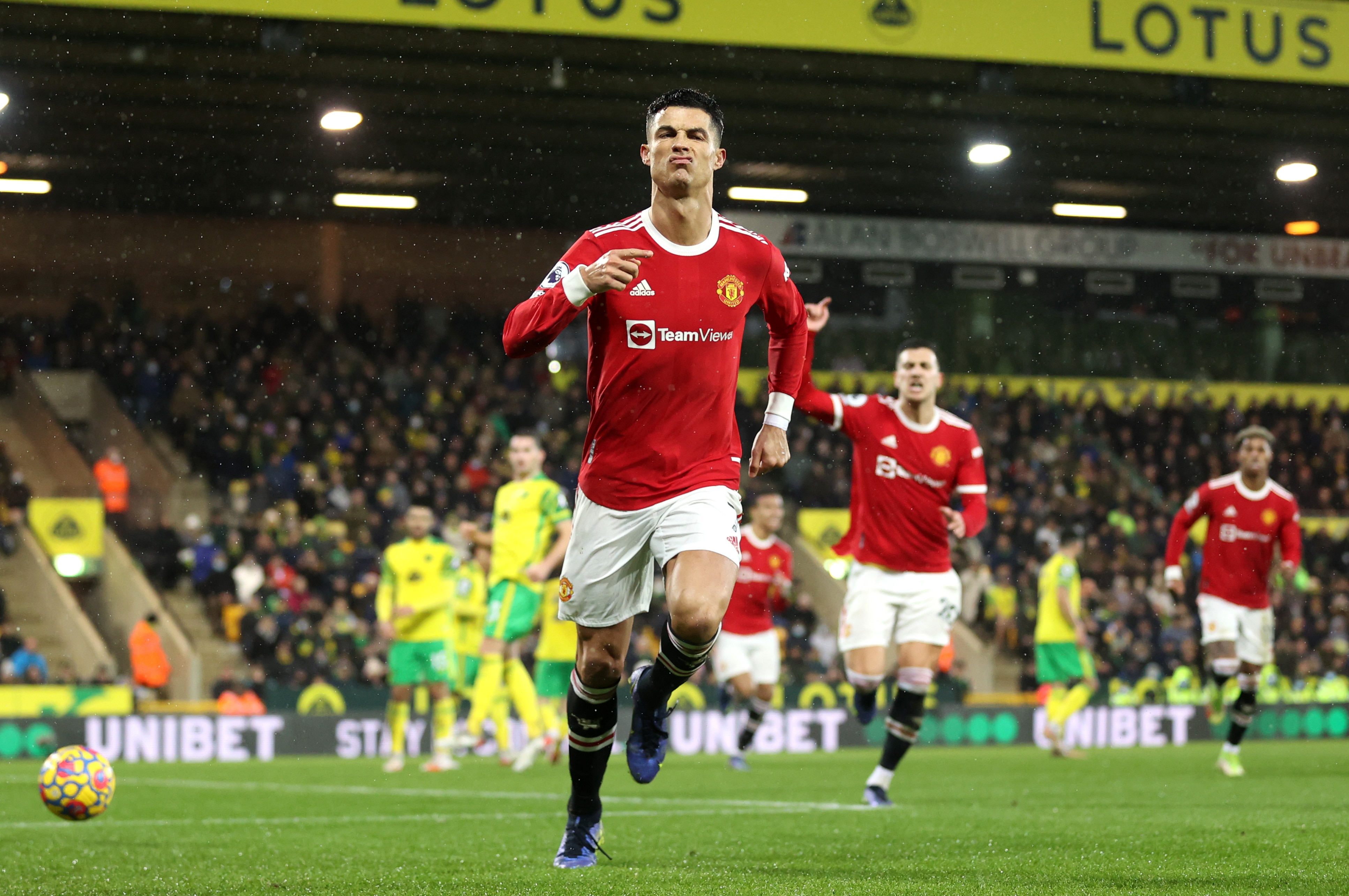 NORWICH, ENGLAND - DECEMBER 11: Cristiano Ronaldo of Manchester United celebrates after scoring his sides first goal from the penalty spot during the Premier League match between Norwich City and Manchester United at Carrow Road on December 11, 2021 in Norwich, England. (Photo by Alex Pantling/Getty Images)