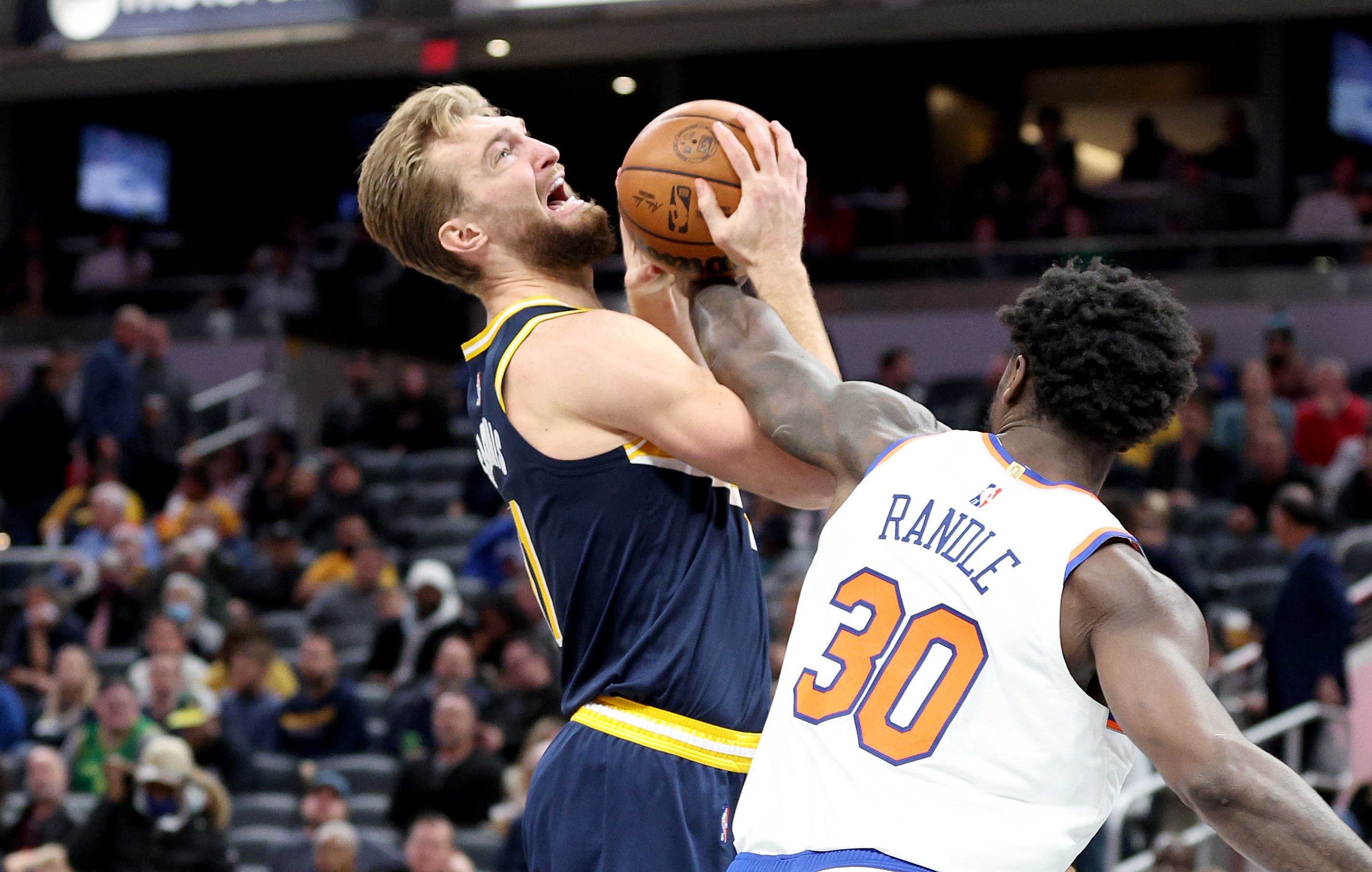 INDIANAPOLIS, INDIANA - DECEMBER 08:  Domantas Sabonis #11 of the Indiana Pacers shoots the ball while defended by Julius Randle #30 of the  New York Knicks at Gainbridge Fieldhouse on December 08, 2021 in Indianapolis, Indiana.     NOTE TO USER: User expressly acknowledges and agrees that, by downloading and or using this Photograph, user is consenting to the terms and conditions of the Getty Images License Agreement.  (Photo by Andy Lyons/Getty Images)
