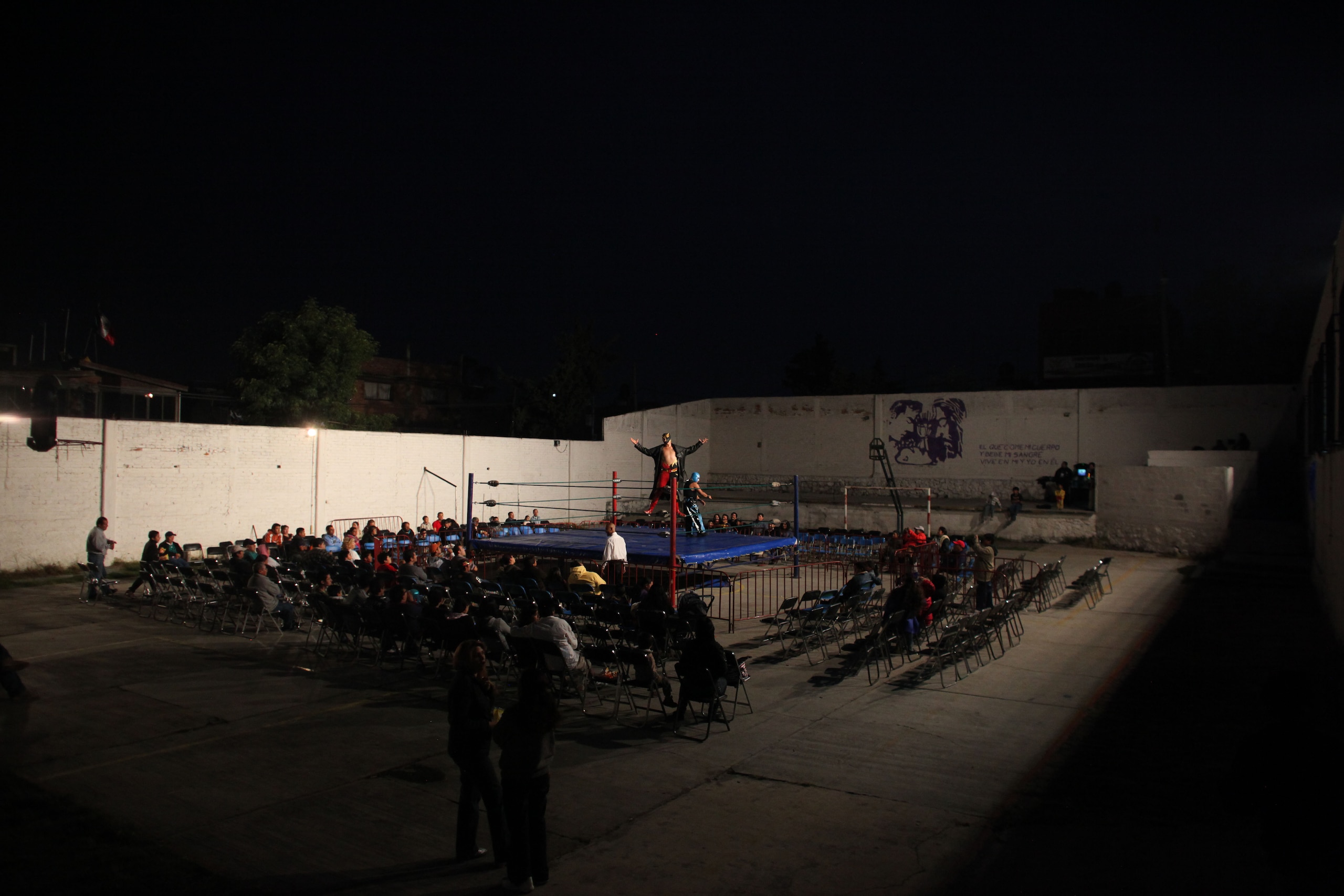 In this photo taken Nov.12, 2011, a Mexican Lucha Libre wrestler performs on a makeshidt wrestling ring in a schoolyard in Mexico City. Independent backyard shows form an underground wrestling circuit for Mexico City's poor who lack the money to buy a 300 pesos ($22) ticket to see a professional wrestling event at one of Mexico City's big arenas. (AP Photo/Alexandre Meneghini)