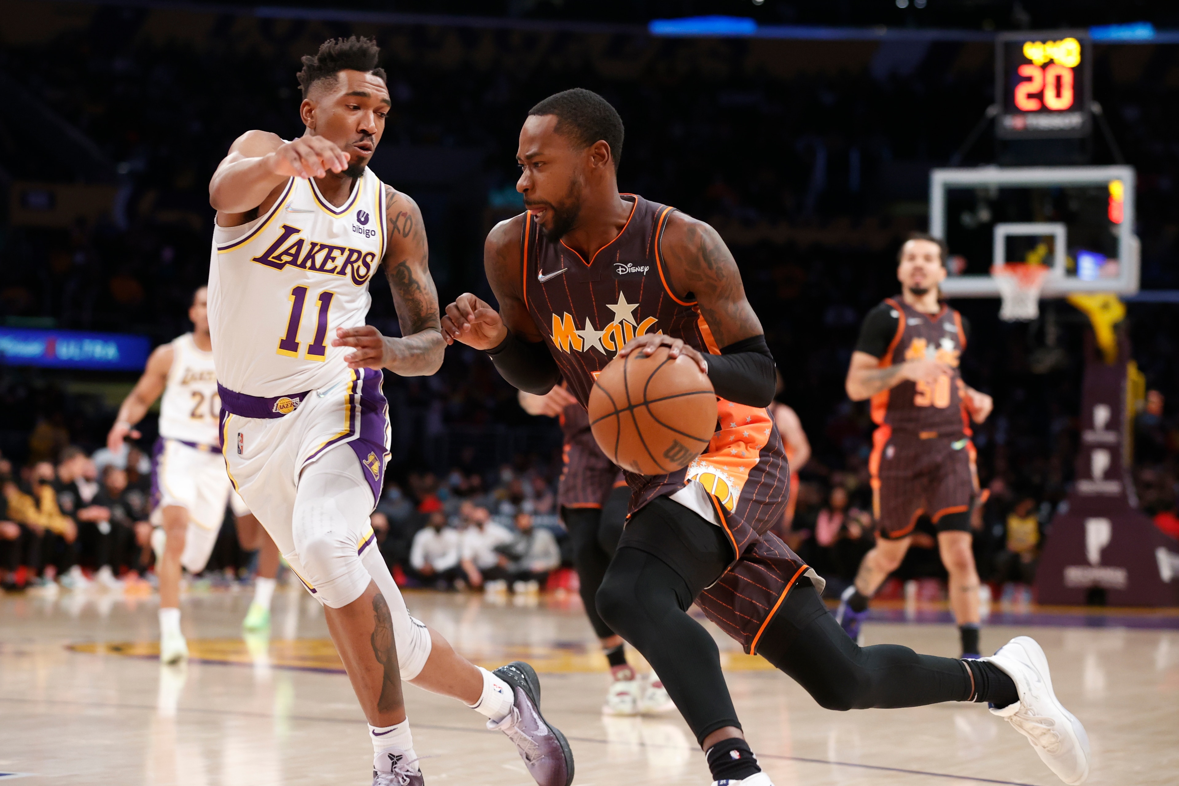 Orlando Magic guard Terrence Ross (31) drives the ball against Los Angeles Lakers guard Malik Monk (11) during the first half of an NBA basketball game in Los Angeles, Sunday, Dec. 12, 2021. (AP Photo/Ringo H.W. Chiu)