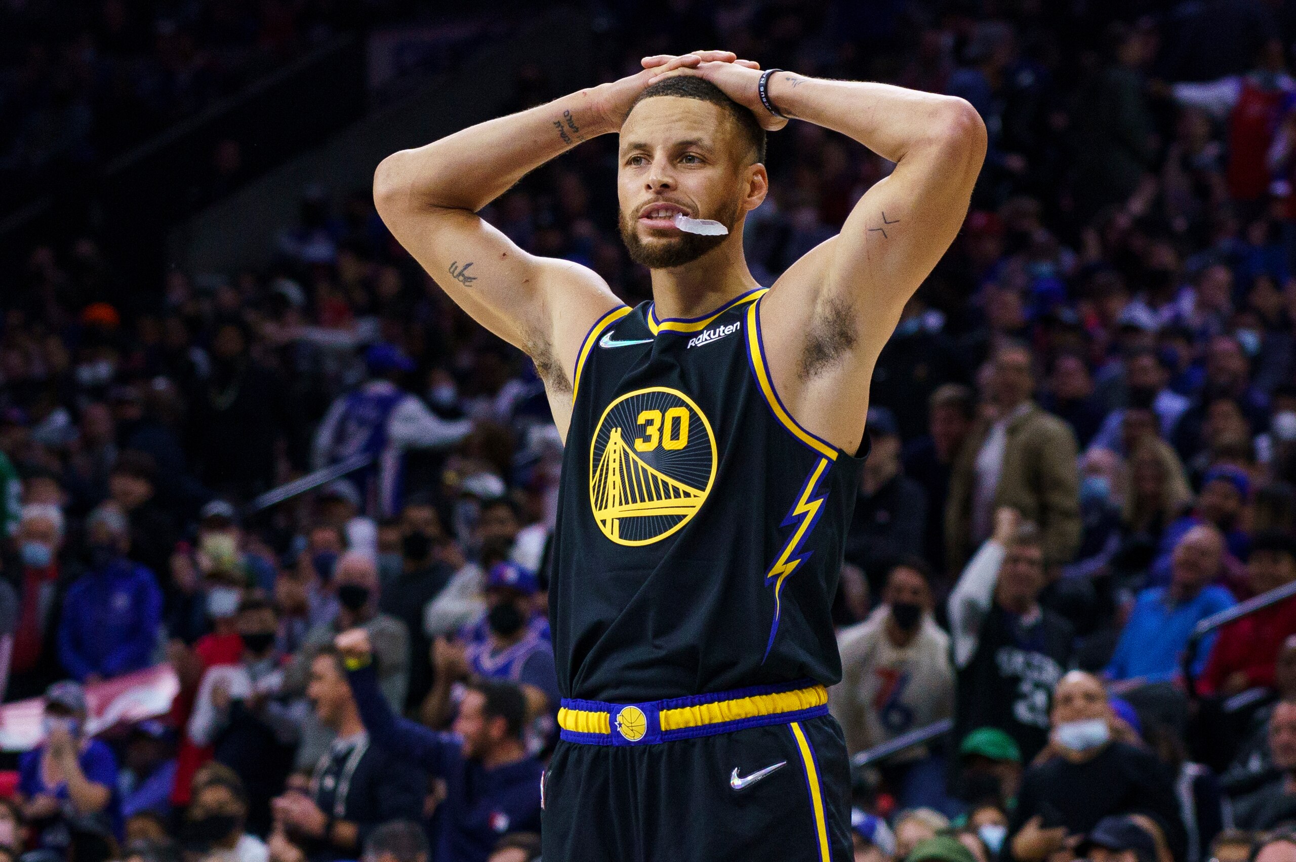 Golden State Warriors' Stephen Curry puts his hands on his head during the second half of an NBA basketball game against the Philadelphia 76ers, Saturday, Dec. 11, 2021, in Philadelphia. (AP Photo/Chris Szagola)