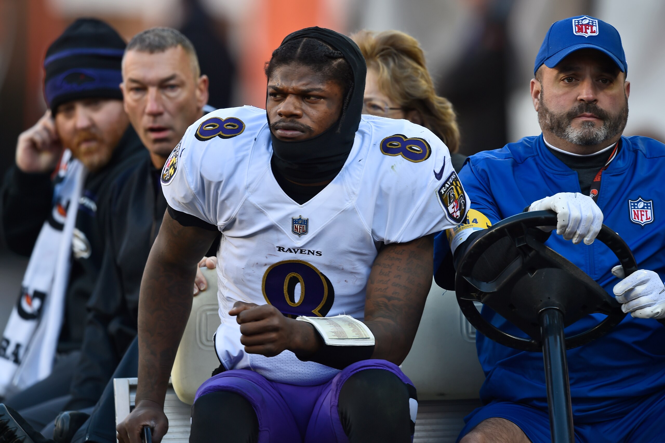 Baltimore Ravens quarterback Lamar Jackson (8) is carted off the field after an injury during the first half of an NFL football game against the Cleveland Browns, Sunday, Dec. 12, 2021, in Cleveland. (AP Photo/David Richard)
