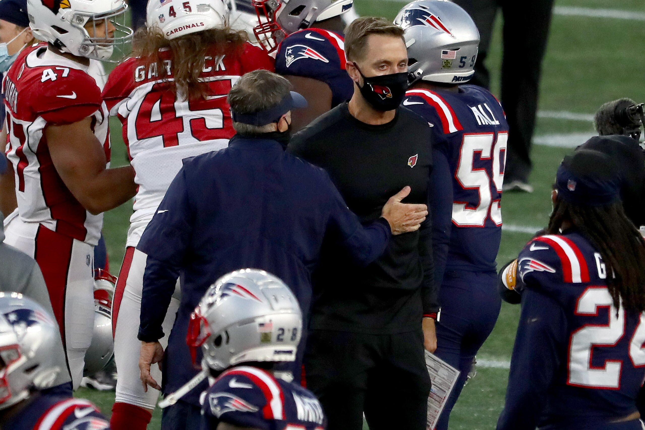 FOXBOROUGH, MASSACHUSETTS - NOVEMBER 29: Head coach Bill Belichick of the New England Patriots talks with head coach Kliff Kingsbury of the Arizona Cardinals after their game at Gillette Stadium on November 29, 2020 in Foxborough, Massachusetts. (Photo by Maddie Meyer/Getty Images)
