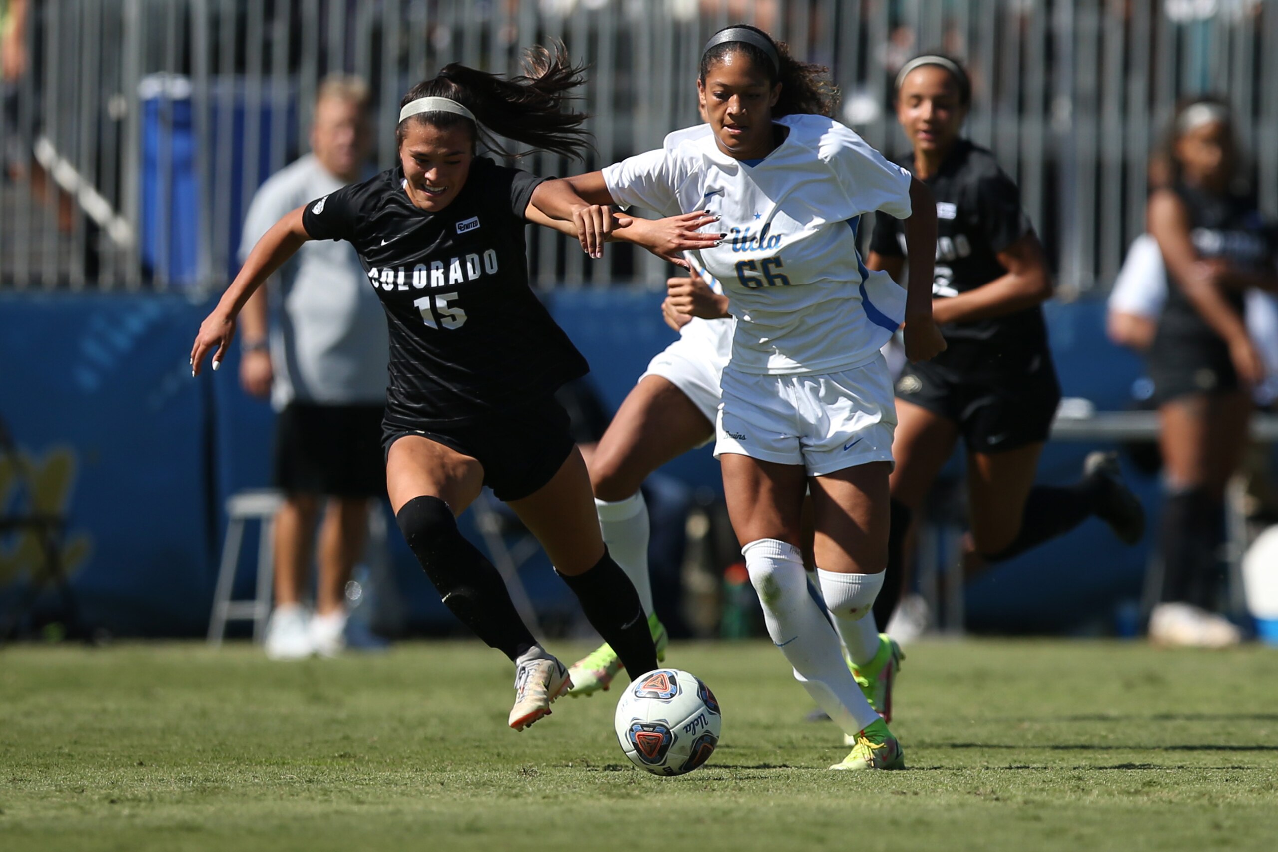 LOS ANGELES, CALIFORNIA - OCTOBER 10: Lawson Willis #15 of the University of Colorado and Reilyn Turner #66 of UCLA fight for control of the ball during a game at Wallis Annenberg Stadium on October 10, 2021 in Los Angeles, California. (Photo by Katharine Lotze/Getty Images)