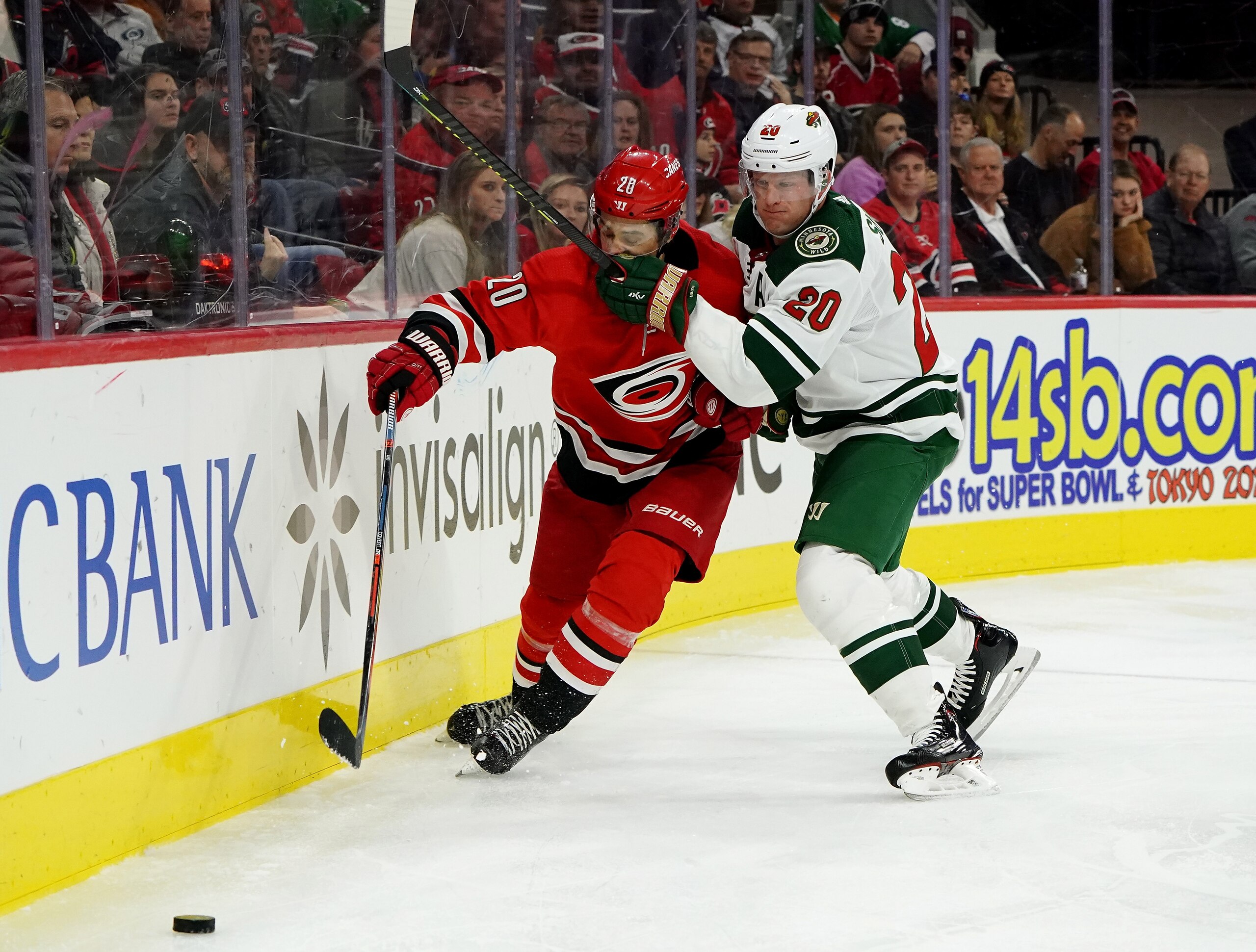 RALEIGH, NC - DECEMBER 07: Sebastian Aho #20 of the Carolina Hurricanes and Ryan Suter #20 of the Minnesota Wild battles along the boards during an NHL game on December 7, 2019 at PNC Arena in Raleigh, North Carolina. (Photo by Gregg Forwerck/NHLI via Getty Images)